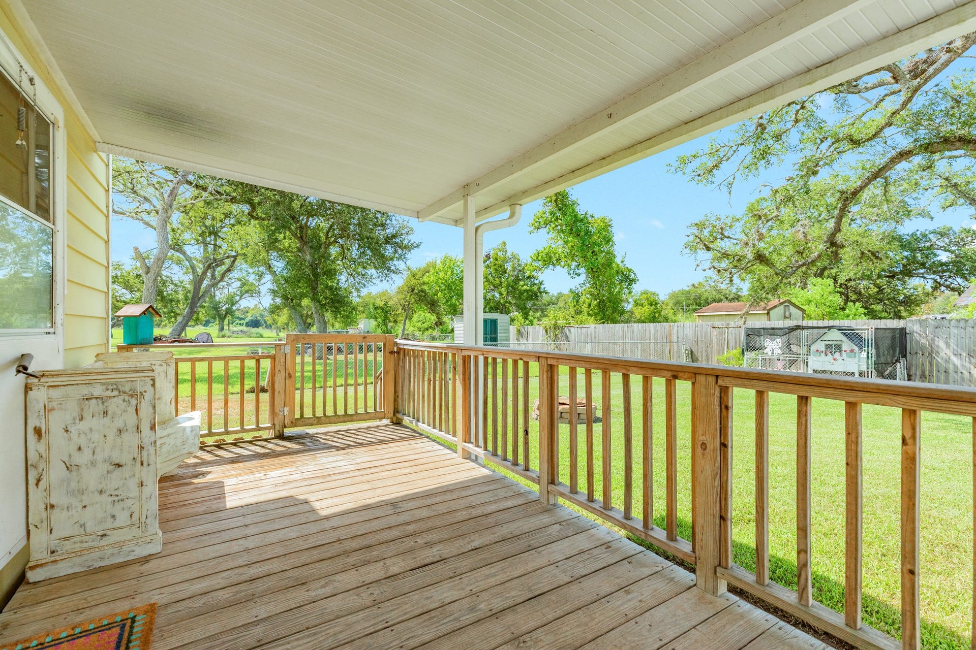Back porch where you can enjoy watching the chickens roam in your backyard. Chicken Coop will convey with the property.