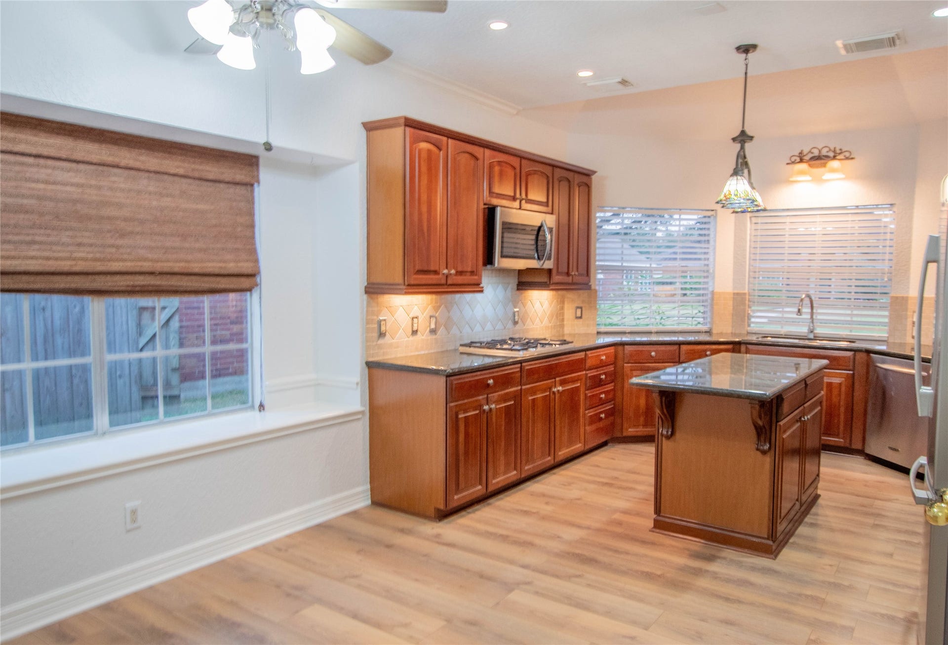 4700 Broadmoor Drive, League City, TX 77573 The open area from the breakfast to the kitchen, the side window is deep enough for a cushion/seating arrangement.