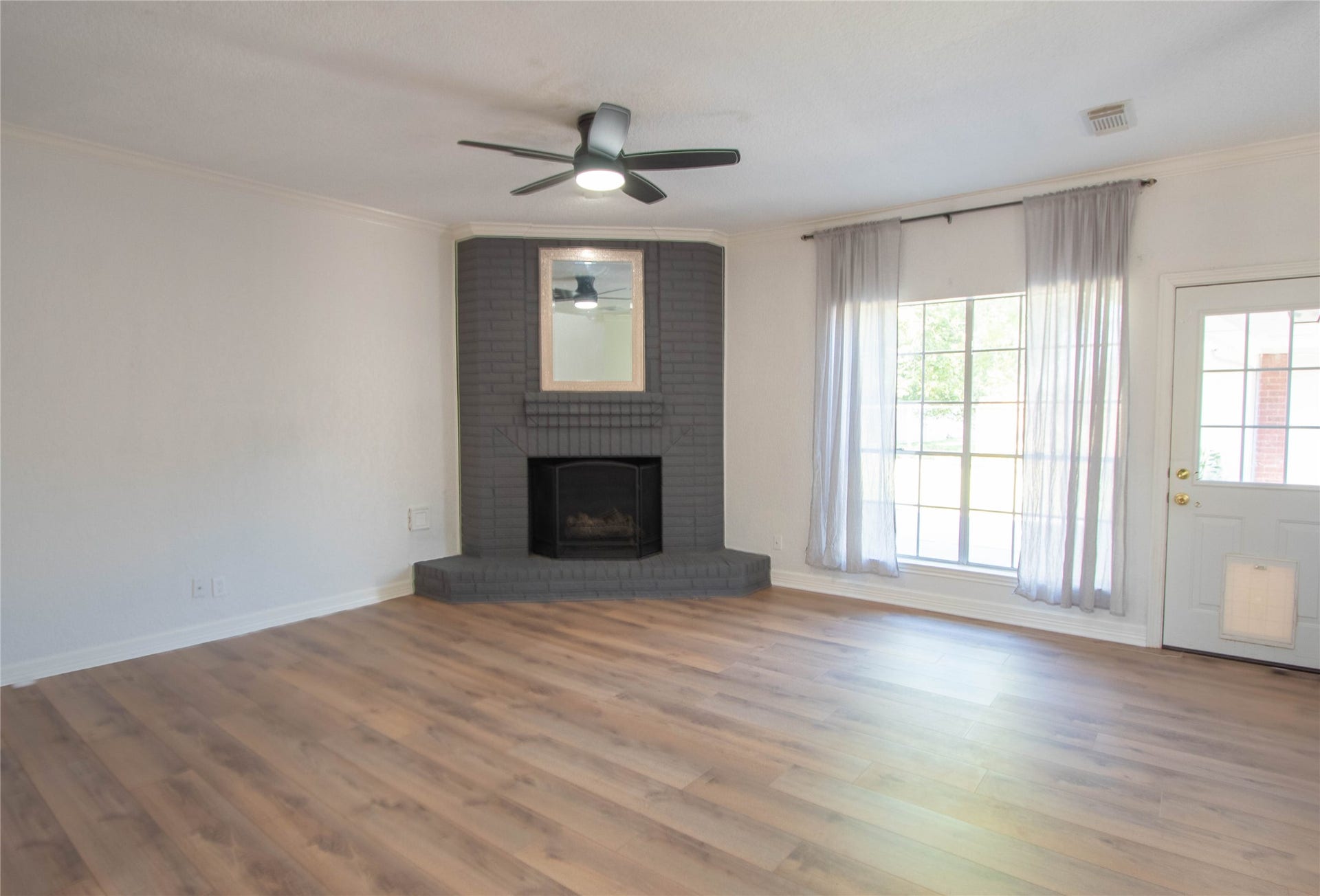 4700 Broadmoor Drive, League City, TX 77573 actual family room, gas log fireplace, laminated flooring, window overlooking at the back patio