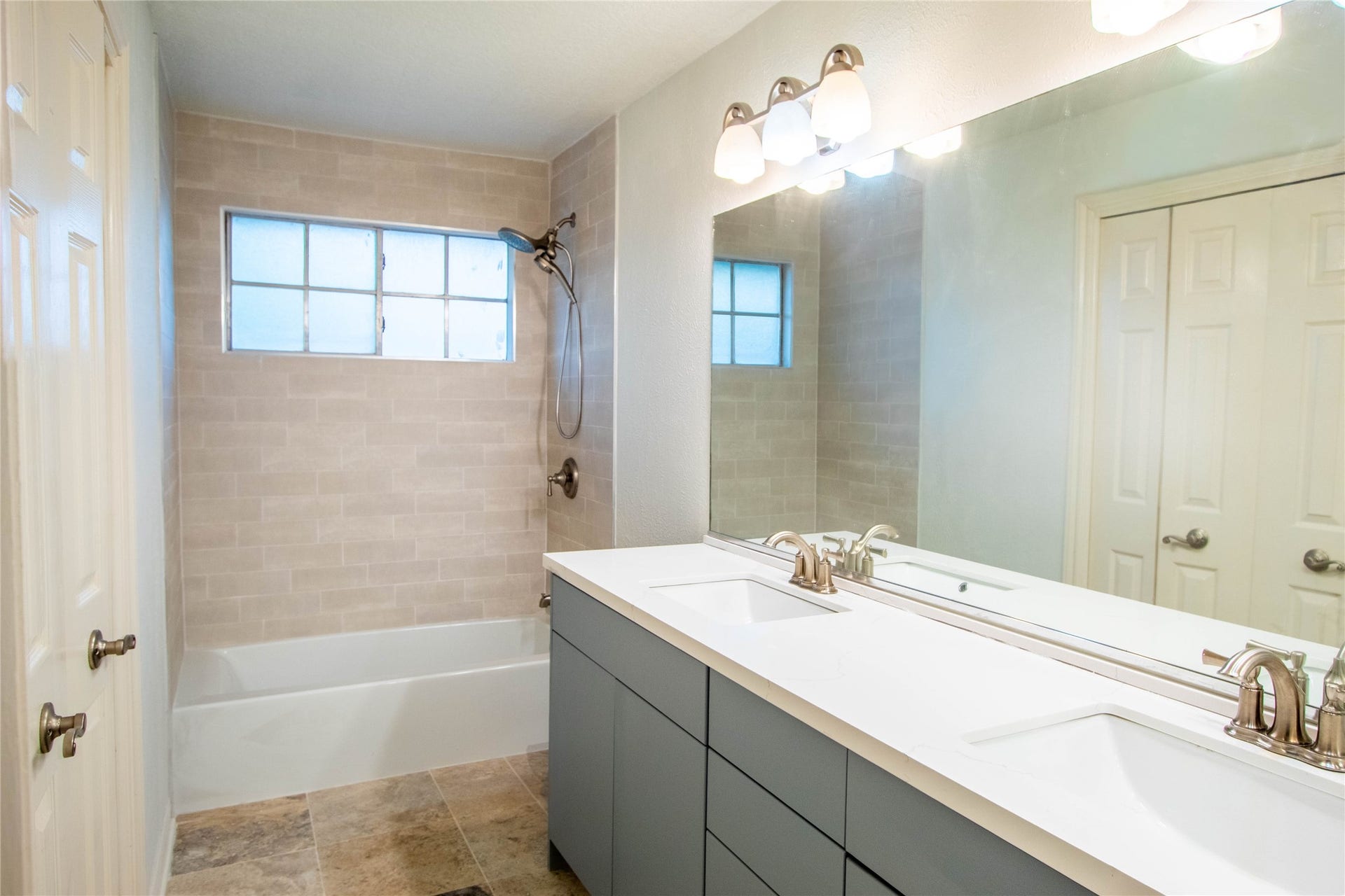 4700 Broadmoor Drive, League City, TX 77573 Second floor bathroom newly updated, new shower from tile to tub. tile flooring, and double sink quartz countertops.
