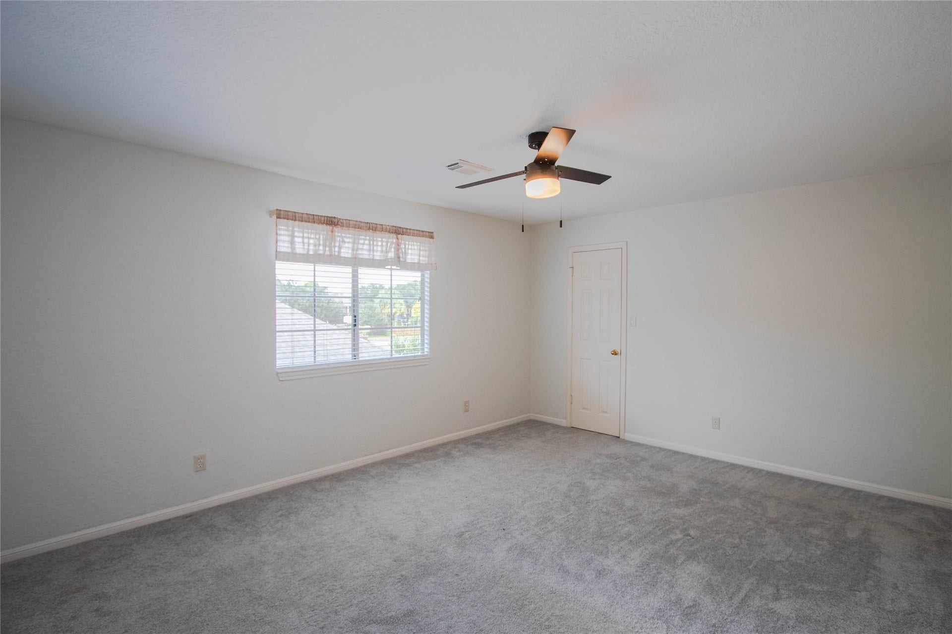4700 Broadmoor Drive, League City, TX 77573 Secondary bedroom, window overlooking the backyard, and walk-in closet.