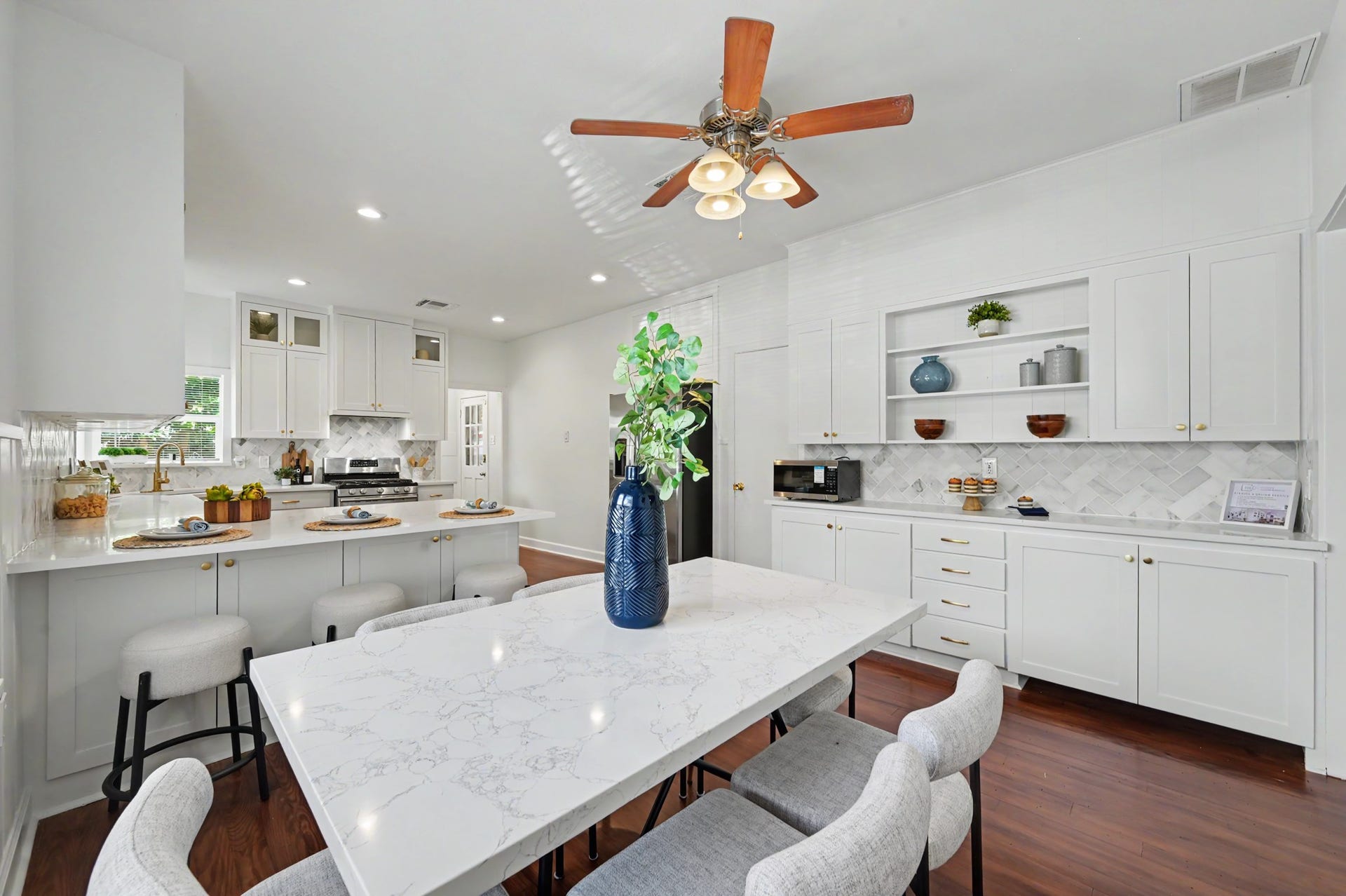 807 Key Street, Houston, TX 77009 Expansive view highlighting the kitchens generous storage, built-in cabinetry, peninsula seating, and adjoining dining area.