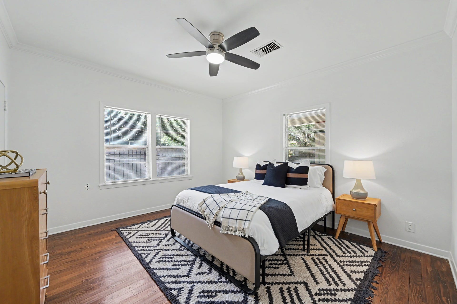 807 Key Street, Houston, TX 77009 Secondary bedroom with hardwood floors, crown molding, ceiling fan, and windows providing natural light from multiple exposures.