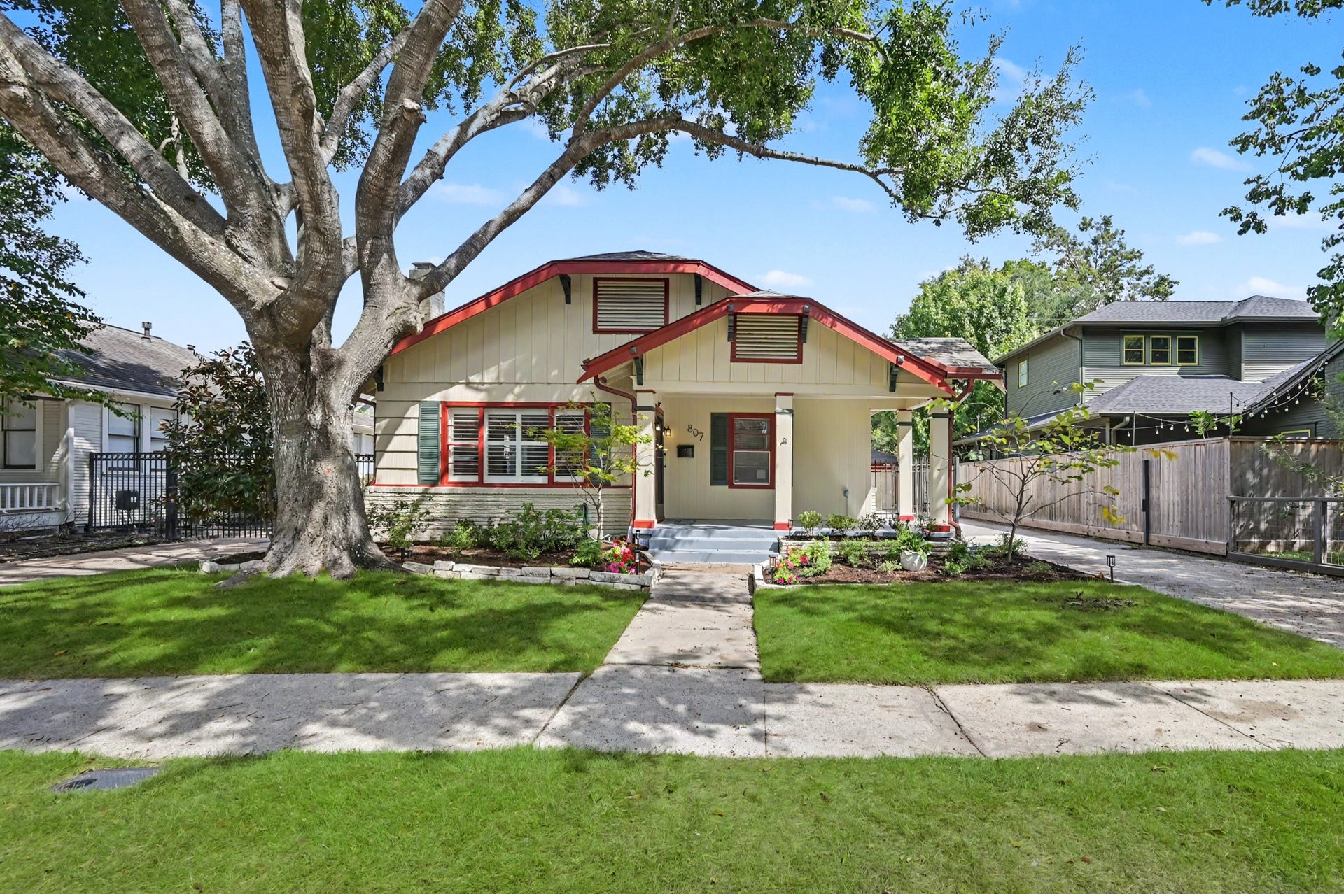 807 Key Street, Houston, TX 77009 Charming Heights bungalow framed by a mature shade tree, fresh landscaping, and a welcoming covered front porch.
