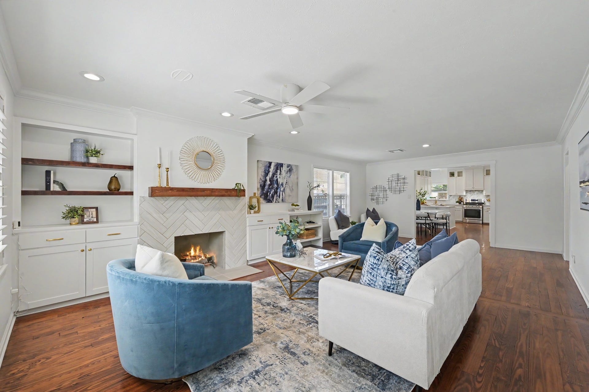 807 Key Street, Houston, TX 77009 Spacious living area featuring warm hardwood floors, recessed lighting, built-in cabinetry and shelving, and a beautifully updated fireplace.