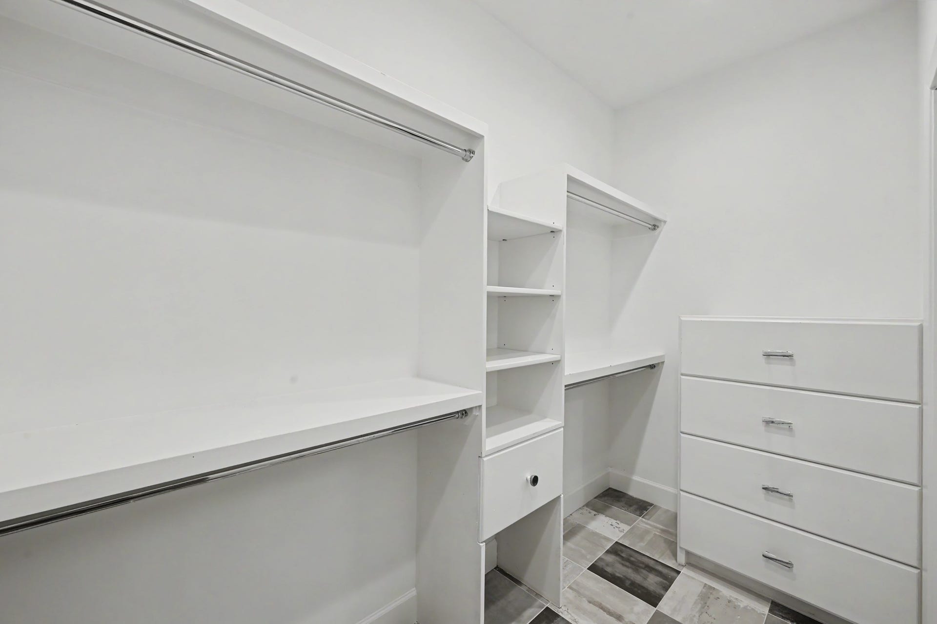 807 Key Street, Houston, TX 77009 Generous walk-in primary closet with built-in shelving, drawers, and multiple hanging areas for organized storage.