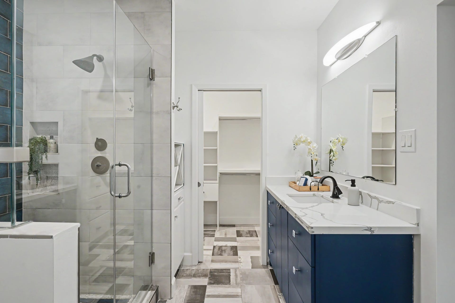 807 Key Street, Houston, TX 77009 Updated primary bath with a glass-enclosed walk-in shower, quartz-topped vanity, and direct access to the walk-in closet.
