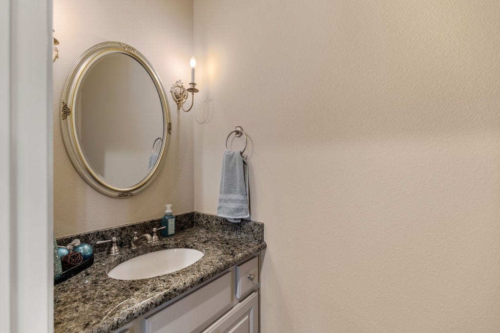 82 Mill Point Place, The Woodlands, TX 77380 A powder room is located downstairs by the utility room.