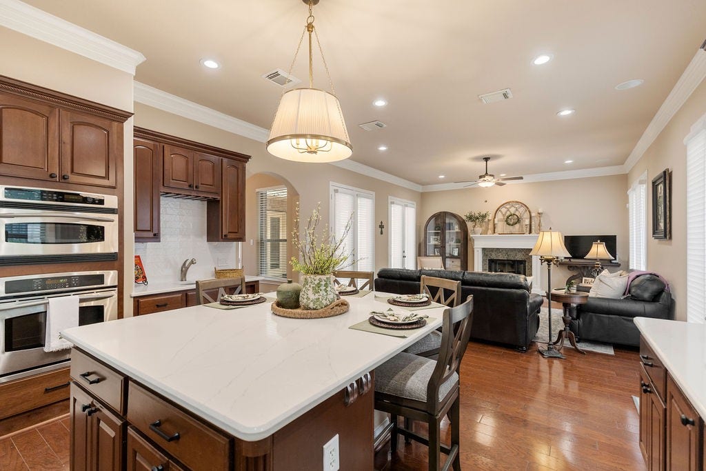 82 Mill Point Place, The Woodlands, TX 77380 Updated light fixtures, kitchen hardware, and bright paint are found throughout the kitchen.