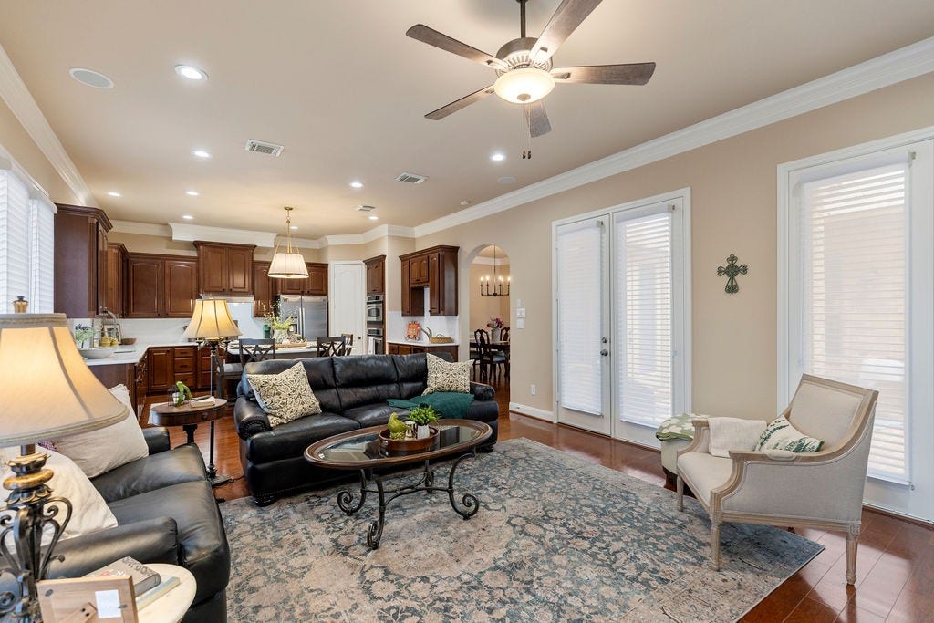 82 Mill Point Place, The Woodlands, TX 77380 The living area opens up to the kitchen downstairs. The doors on the right take you out to the courtyard.