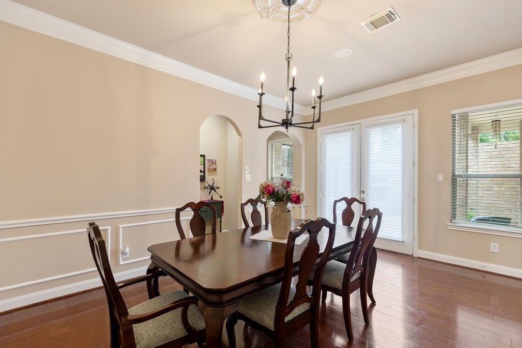 82 Mill Point Place, The Woodlands, TX 77380 Another view of the formal dining. Notice the double doors that open up into the courtyard.