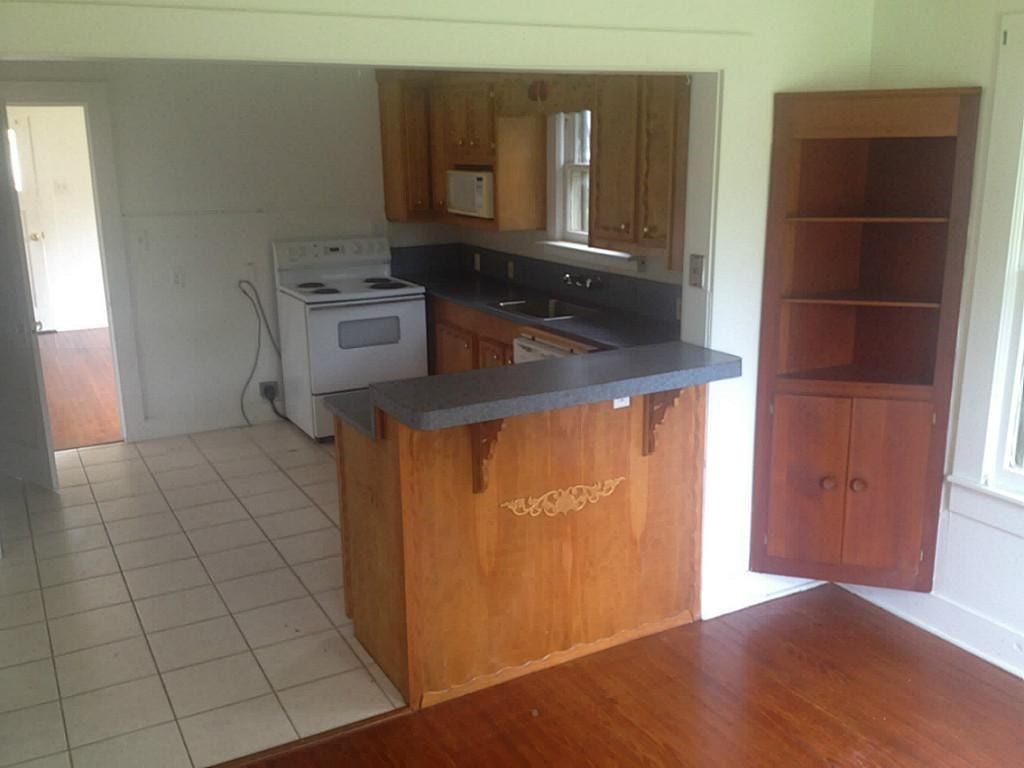 316 S Nugent Street, La Porte, TX 77571 View of kitchen from dining room featuring built in cabinetry