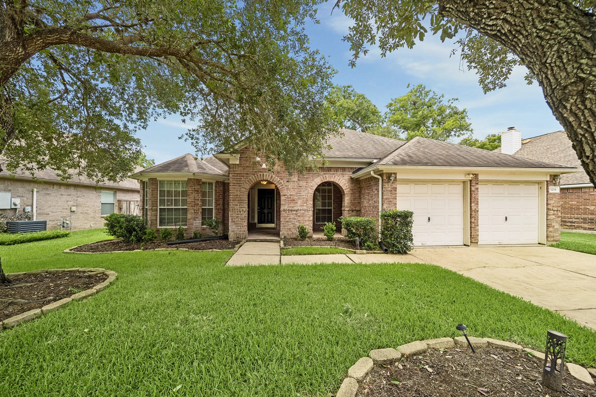 Introducing 1314 Deerbrook Drive, a single-story brick beauty shaded by mature oak trees in one of Greatwood's most sought-after sections. Close to parks, pools, and top-rated schools