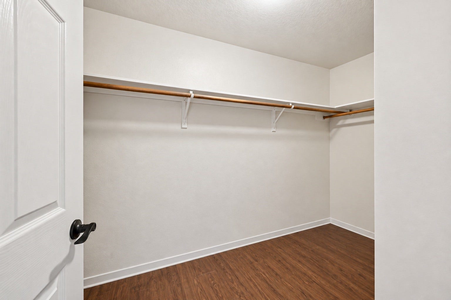 2331 Princess Deanna Lane, Katy, TX 77493 Virtually Cleaned: Offering generous square footage, this primary walk-in closet includes built-in hanging rods and upper storage ledges along multiple walls.