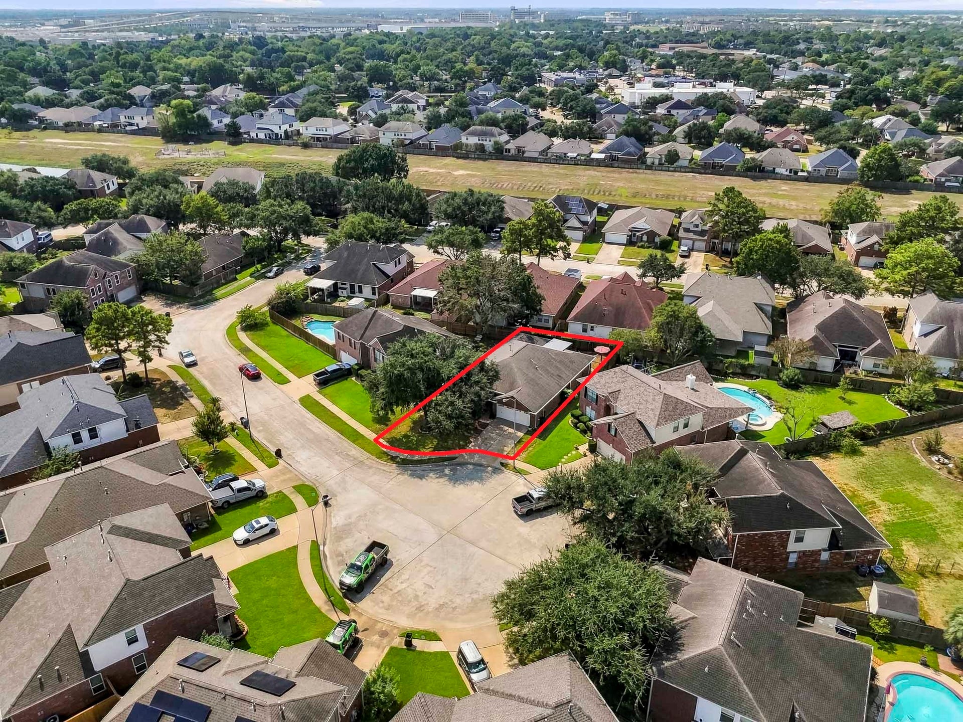 2331 Princess Deanna Lane, Katy, TX 77493 Highlighting the propertys ideal placement on a quiet cul-de-sac street, this aerial perspective provides a clear view of the home's roofline, front driveway, and surrounding grounds.