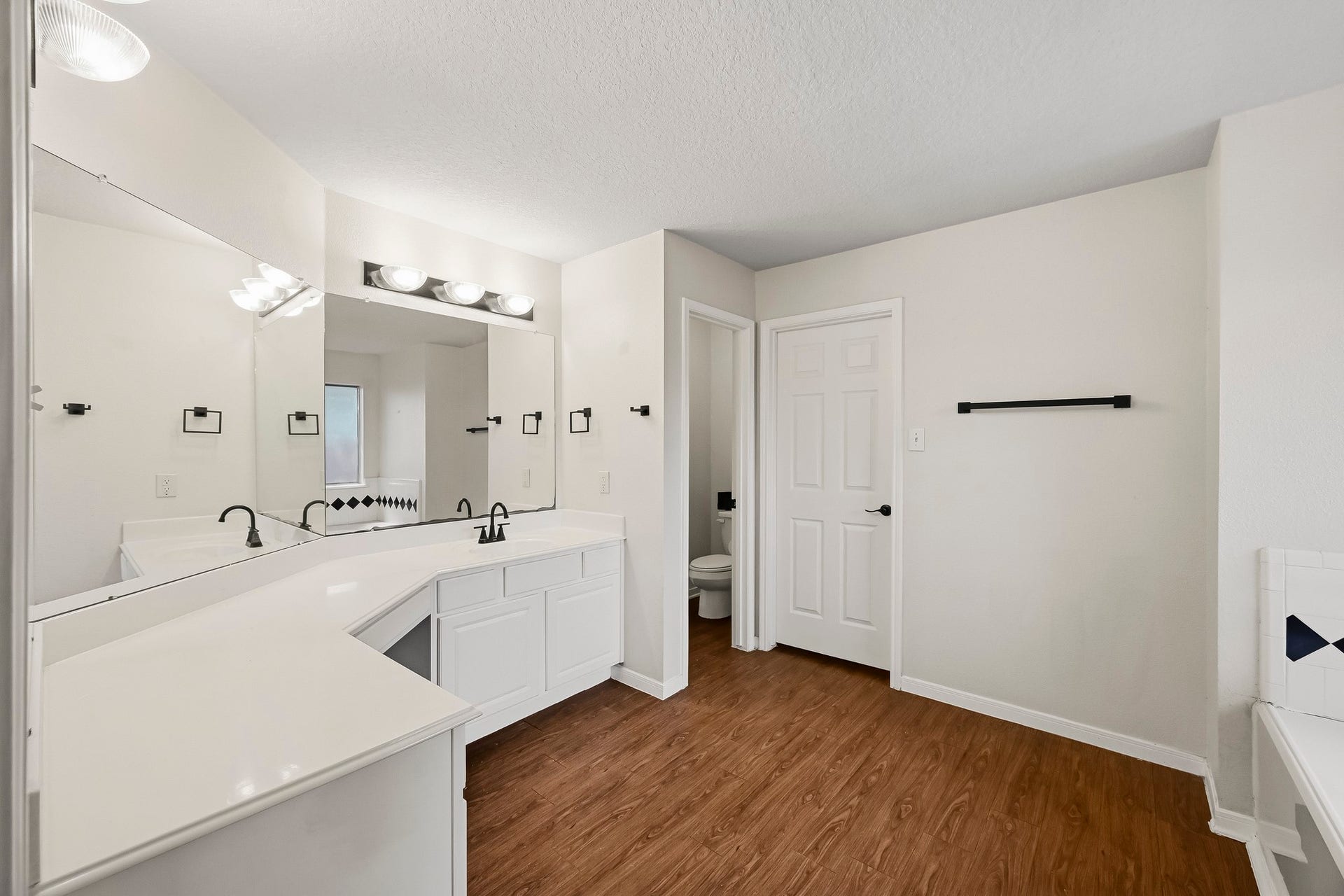 2331 Princess Deanna Lane, Katy, TX 77493 This spacious primary bathroom features an expansive wrap-around vanity with abundant counter space, lower cabinet storage, and wide vanity mirrors with overhead vanity lighting.