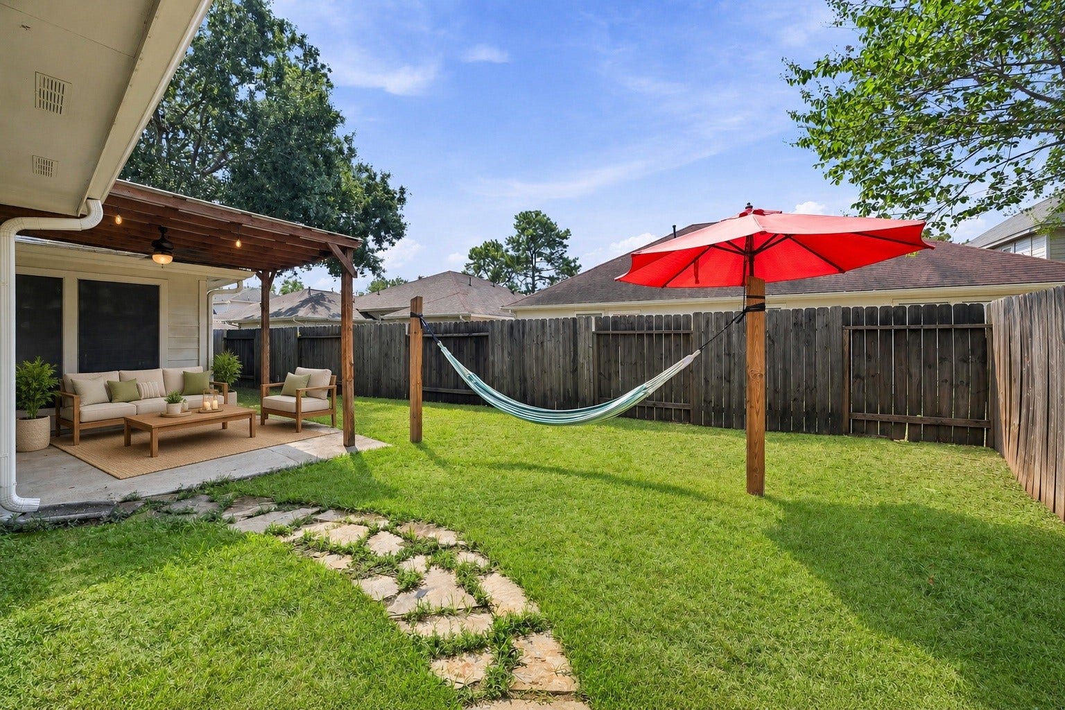 2331 Princess Deanna Lane, Katy, TX 77493 Virtually Staged: Designed for outdoor enjoyment, this private yard combines a grassy open space with functional patio coverage.