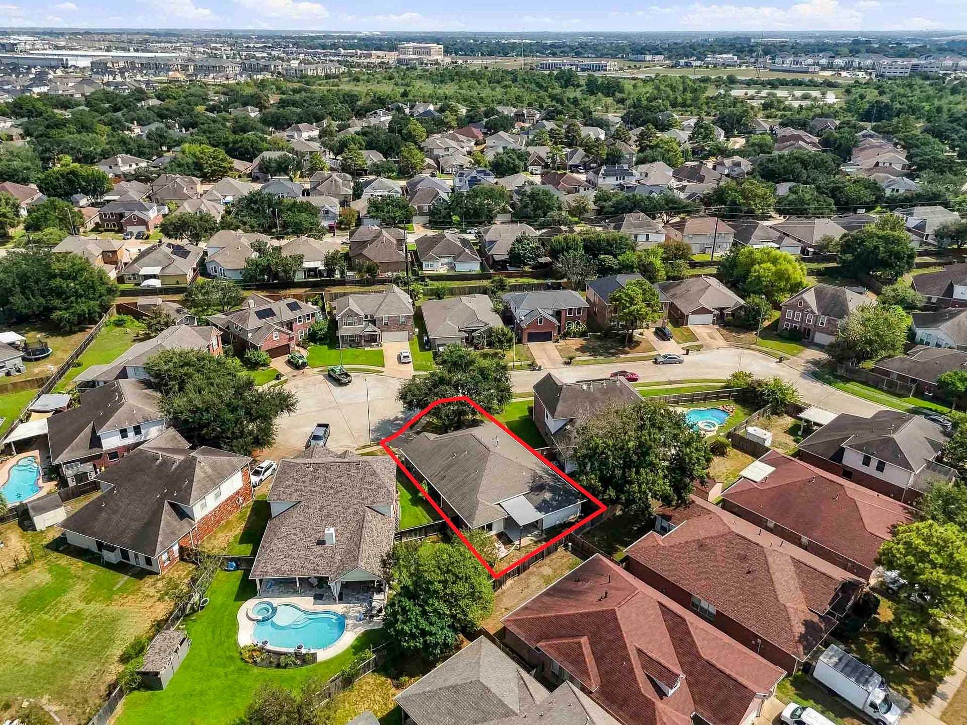 2331 Princess Deanna Lane, Katy, TX 77493 Offering a broad neighborhood view, this aerial photo illustrates the property's peaceful setting surrounded by mature trees and well-maintained single-family homes.