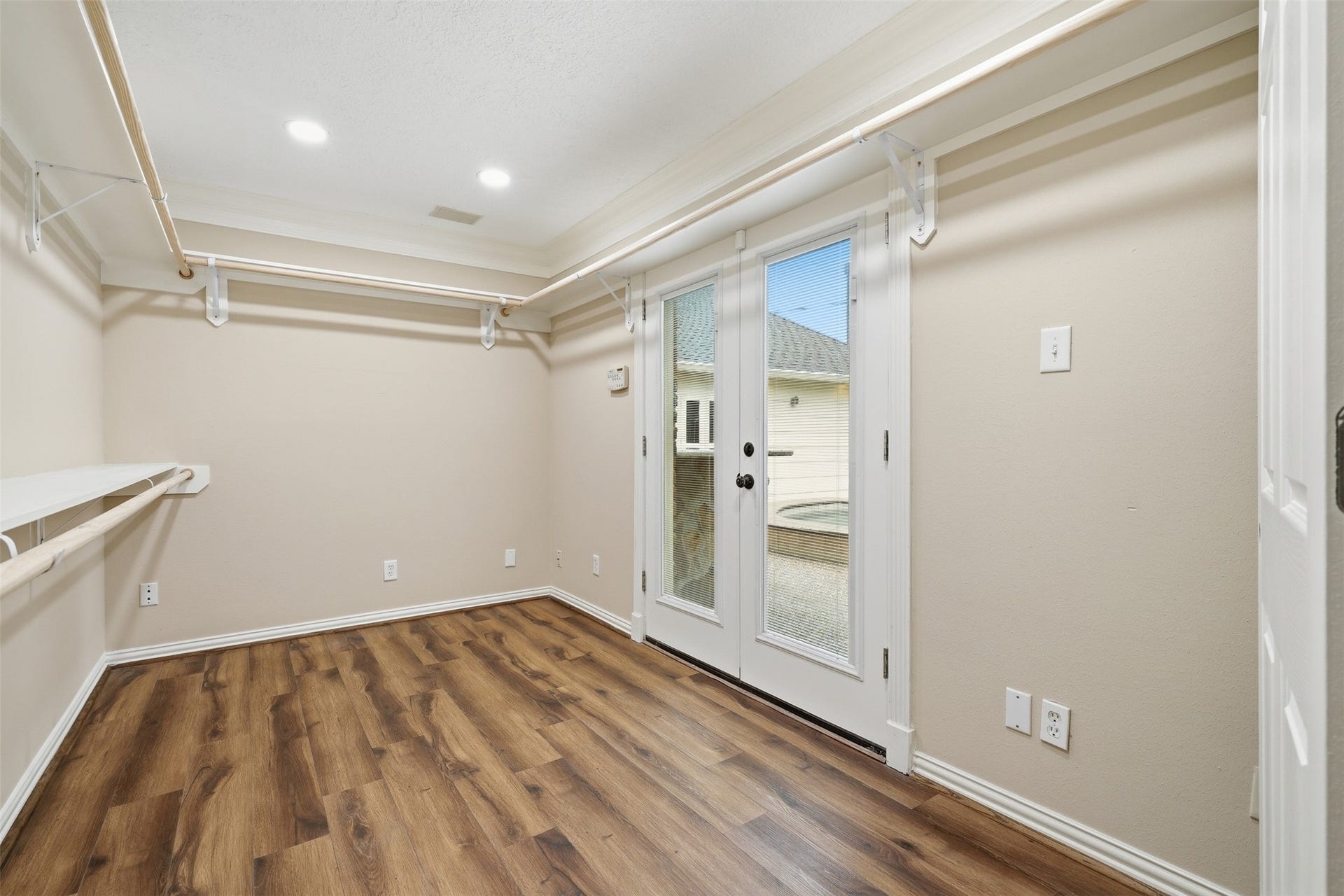 This closet is on the first floor off of the primary bedroom. The double doors open up to the backyard.