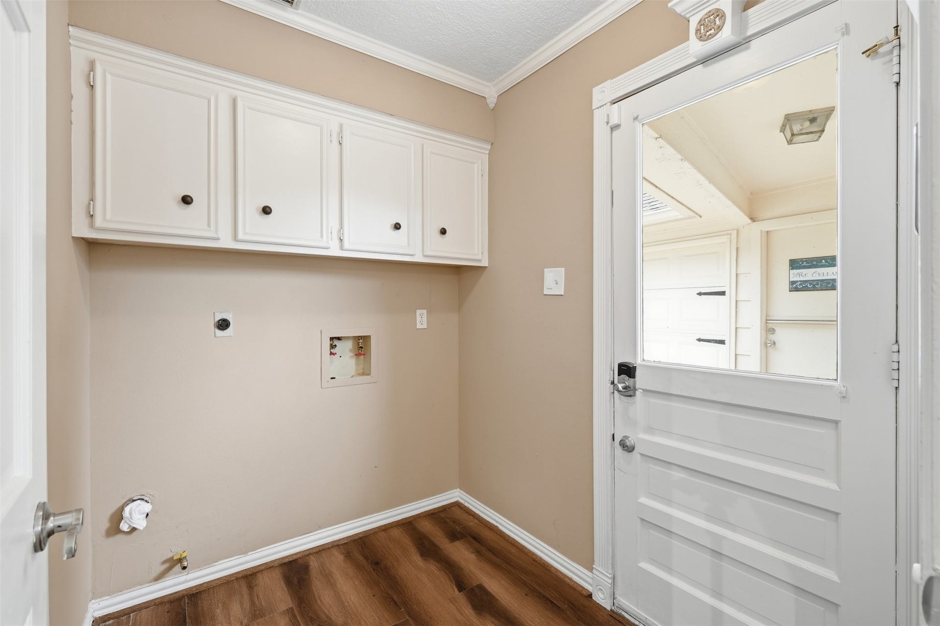 Spacious utility room provides additional storage and functionality for everyday household needs.