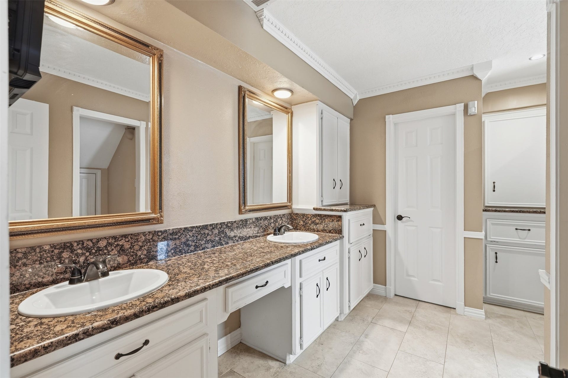 The primary bathroom features 2 sinks, elegant finishes, and a thoughtfully designed layout.