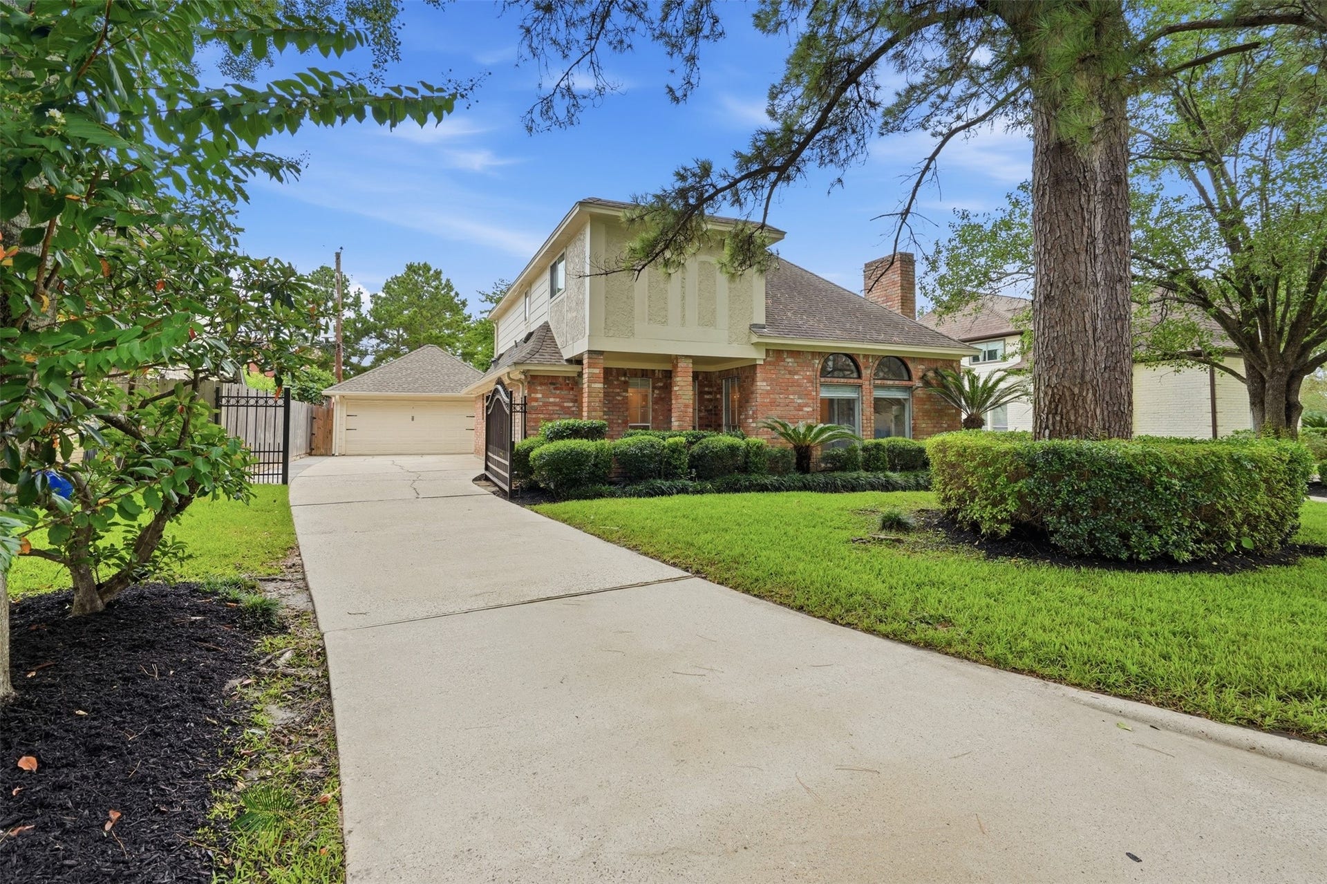 Another view of the front elevation showcasing the long driveway.