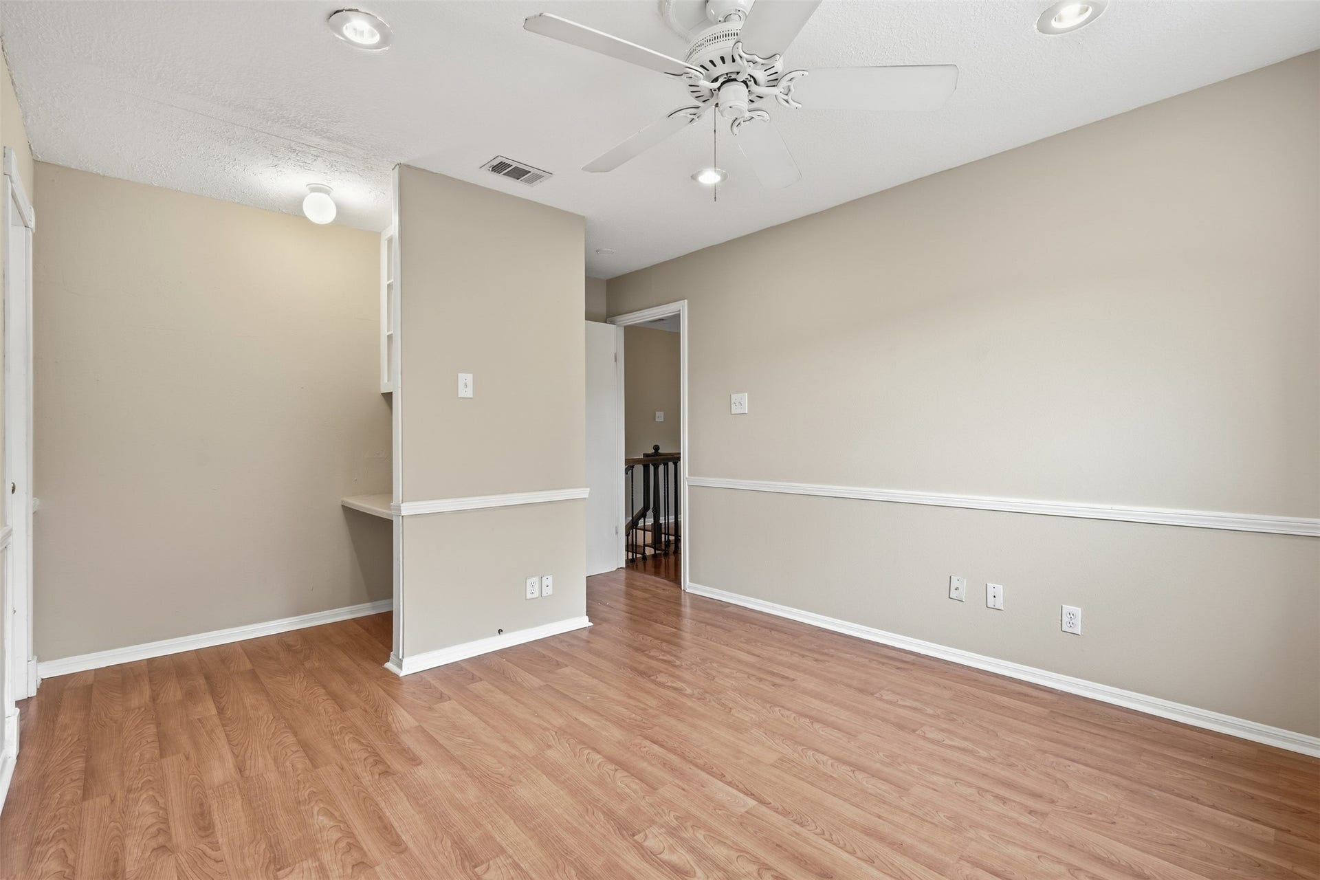 Bright and inviting secondary bedroom with generous proportions and convenient access to nearby bathrooms.