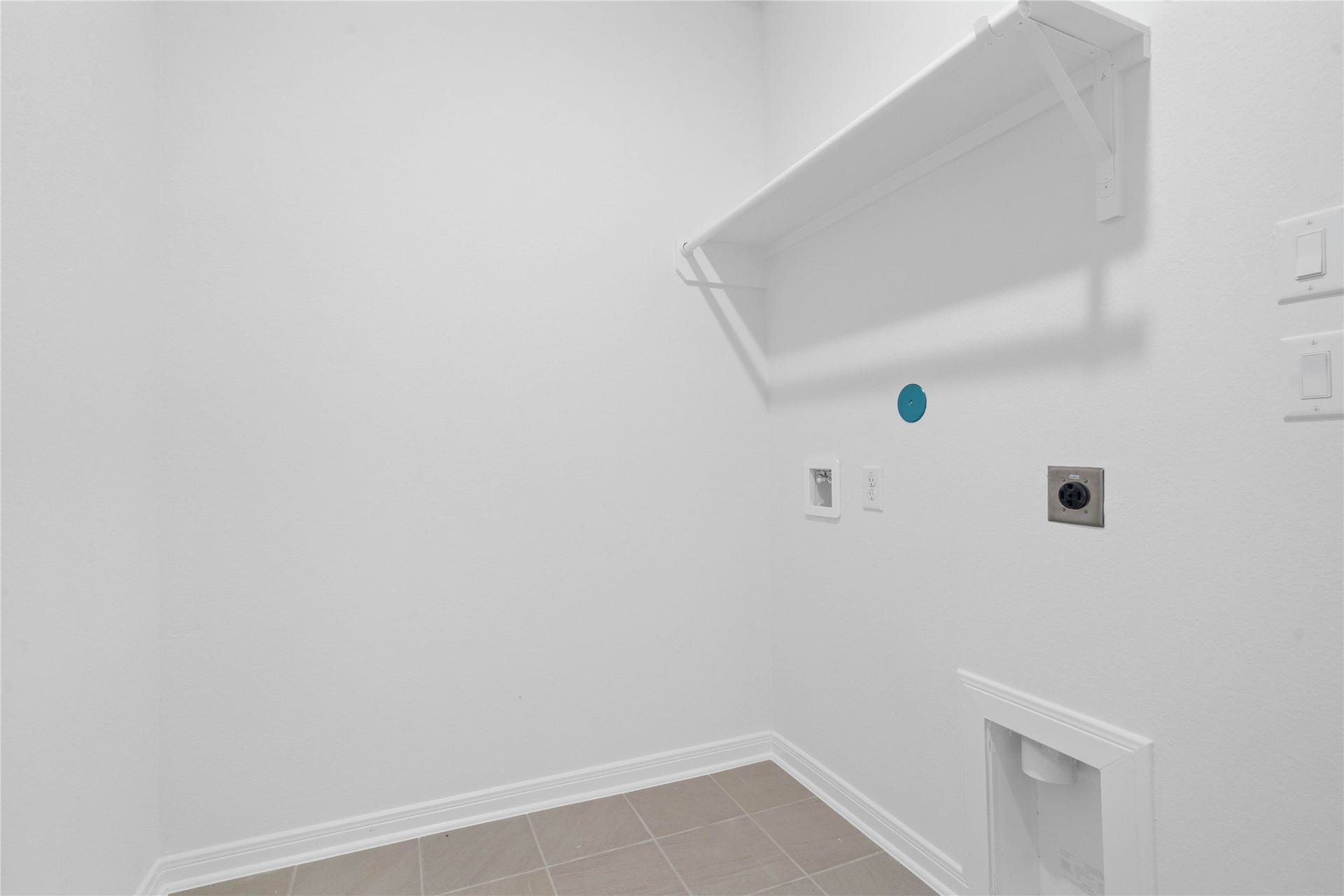 5623 Blackbird Lane, Hitchcock, TX 77563 The laundry room features durable Dune colored tile flooring and a functional layout designed to make everyday household tasks more convenient.