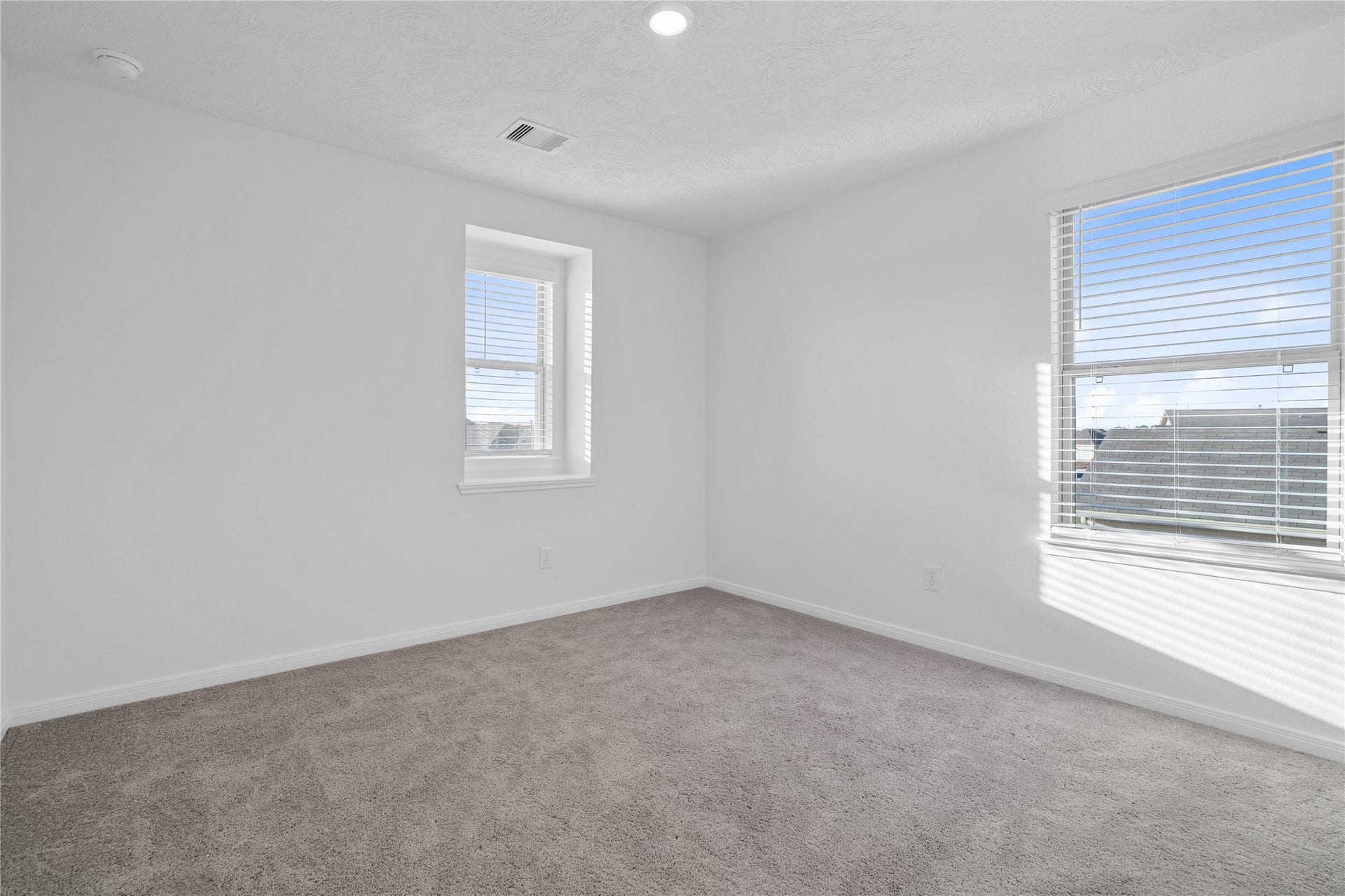 5623 Blackbird Lane, Hitchcock, TX 77563 This upstairs bedroom features soft gray carpeting, neutral walls, and a bright, comfortable atmosphere. Its versatile layout makes it ideal for family, guests, or a personal home office.
