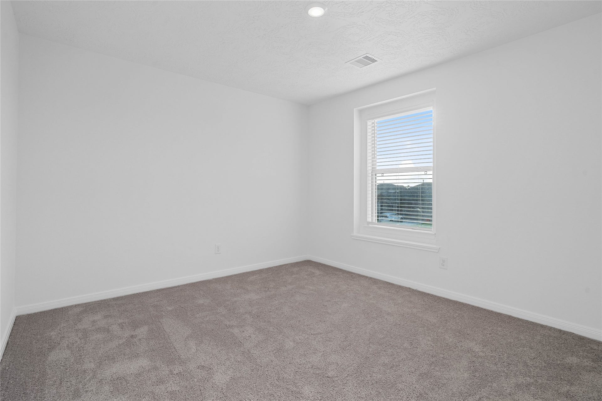 5623 Blackbird Lane, Hitchcock, TX 77563 Enjoy another inviting bedroom with plush gray carpeting and clean, neutral finishes that make the space easy to personalize. Whether used as a guest room, creative space, or additional bedroom, it offers comfort and flexibility.