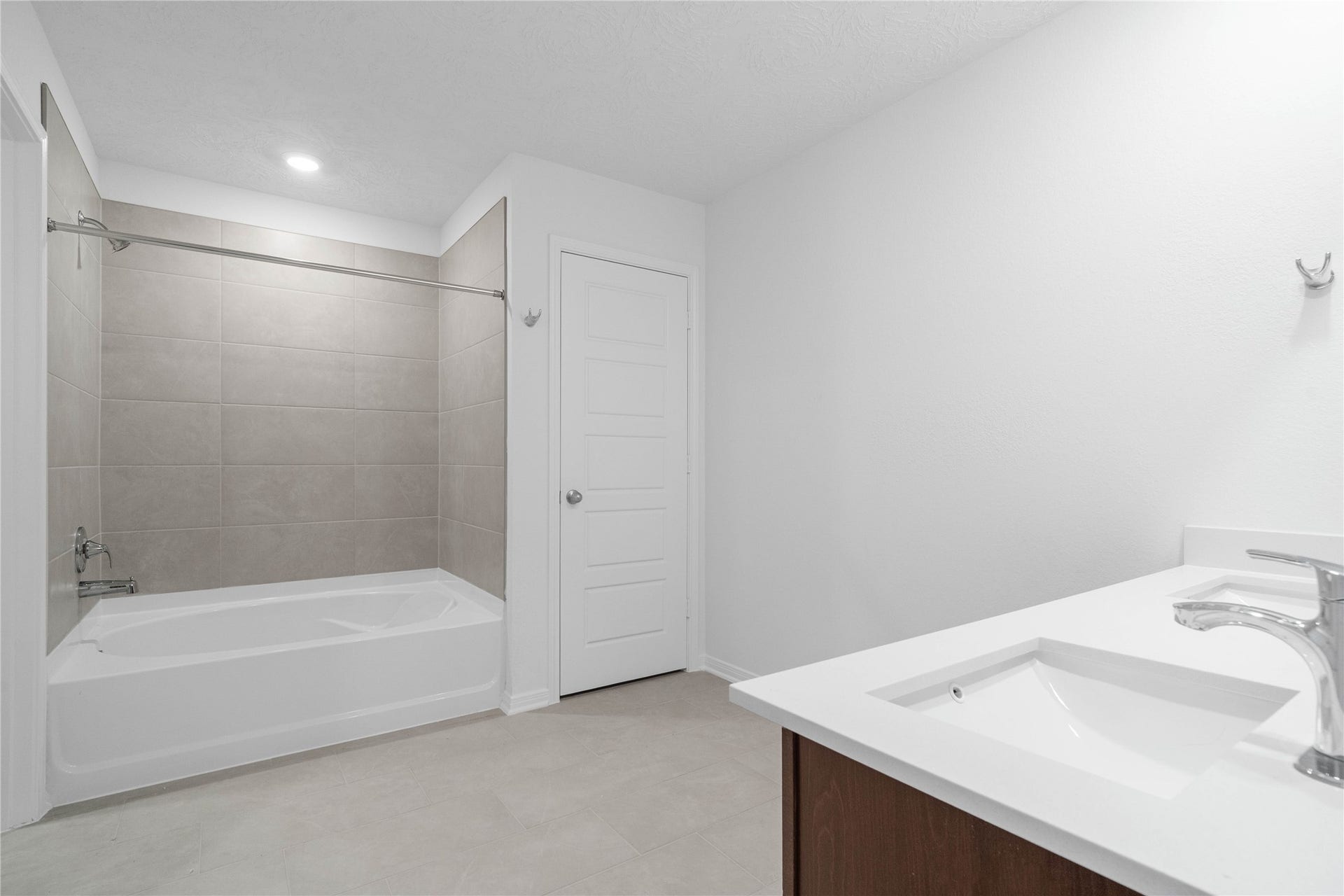 5623 Blackbird Lane, Hitchcock, TX 77563 Enjoy a functional primary bathroom with two sinks, a spacious vanity, and a tiled tub and shower combination. Soft neutral finishes bring a cohesive look to this everyday retreat.