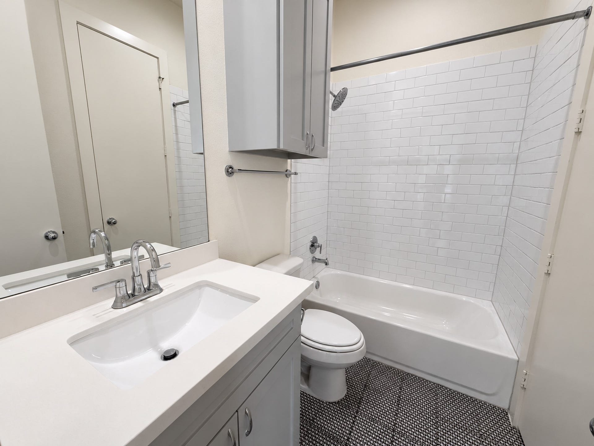 2906 Cline Street, Houston, TX 77020 Second-floor bathroom featuring a sleek vanity, modern fixtures, and a subway-tiled tub and shower combination.