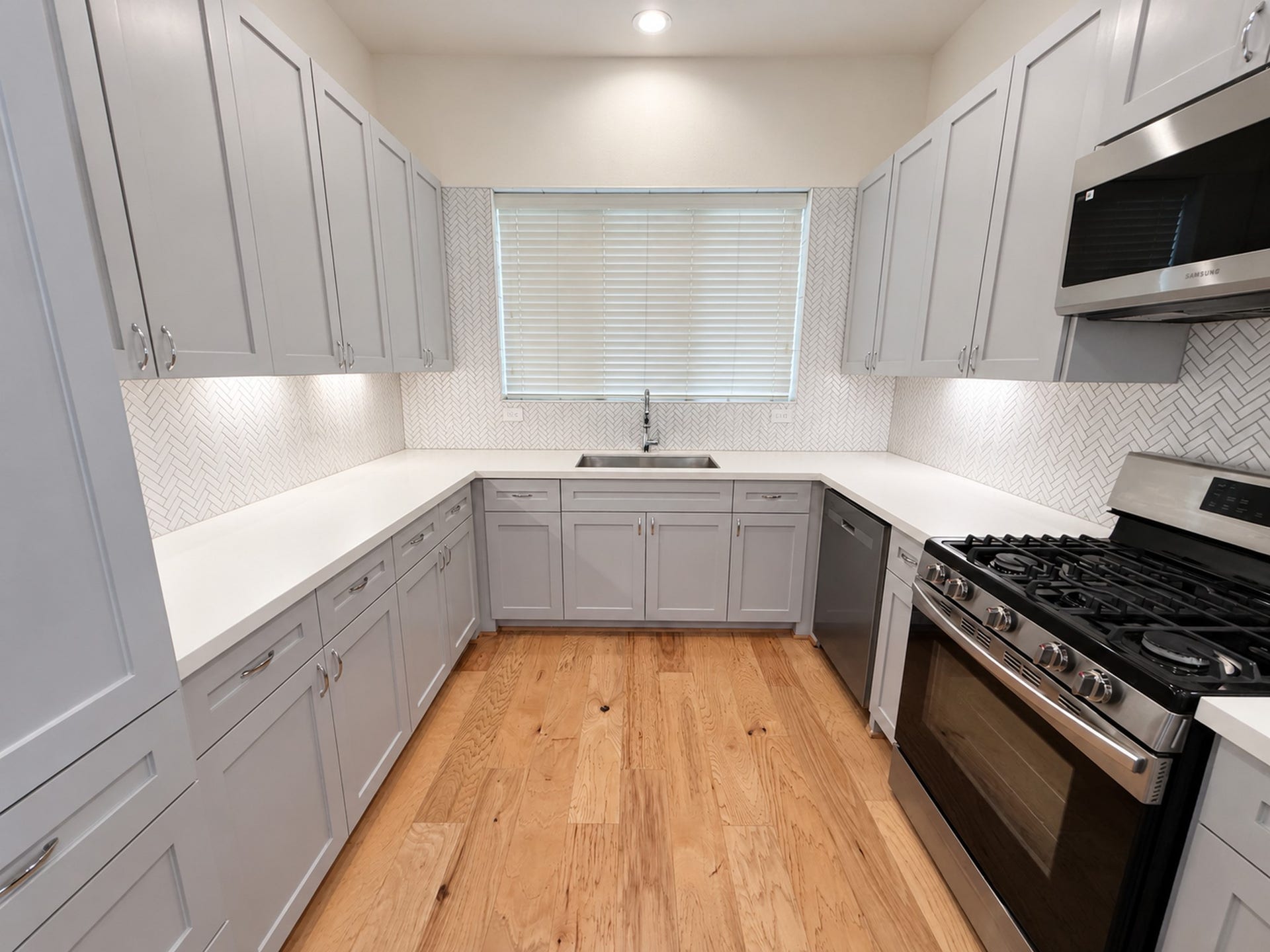 2906 Cline Street, Houston, TX 77020 Modern kitchen with beautiful countertops, stainless steel appliances, ample cabinetry, and a stylish tile backsplash.