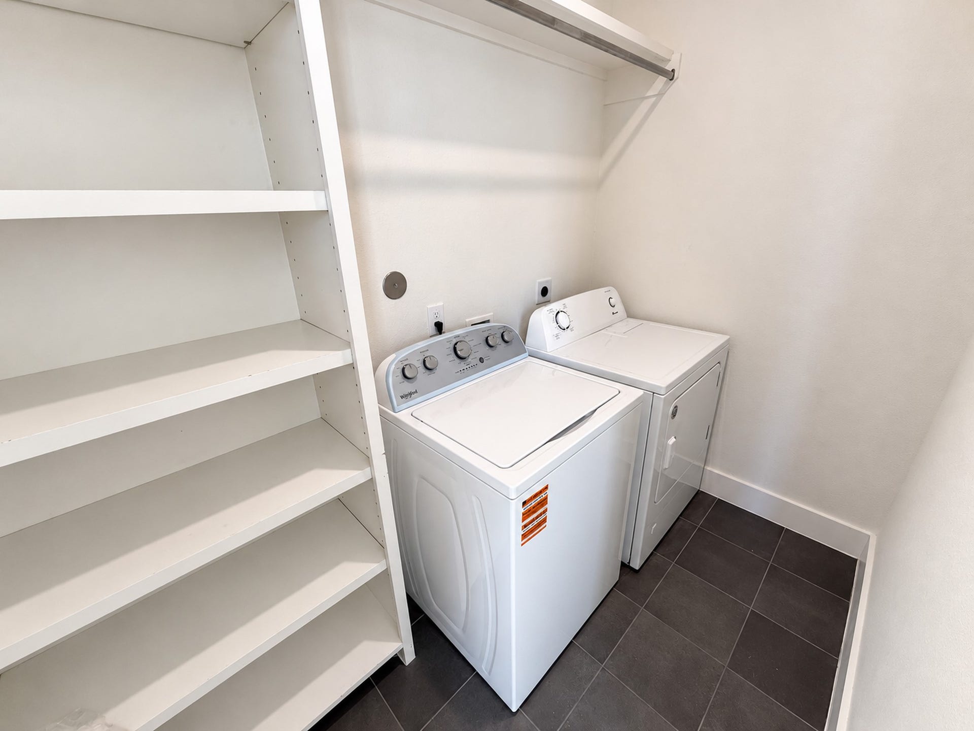 2906 Cline Street, Houston, TX 77020 Convenient third-floor laundry room with a washer, dryer, and built-in storage shelves.