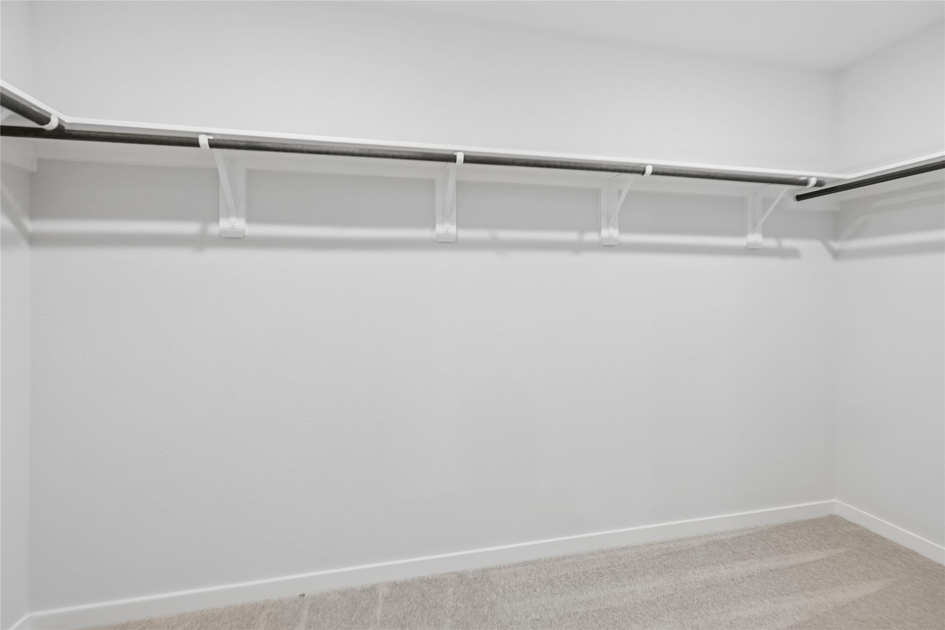 7806 Bergamot Cir, Magnolia, TX 77354 Expansive and well-organized, the primary closet offers ample space for all your wardrobe needs with sleek shelving and hanging options.