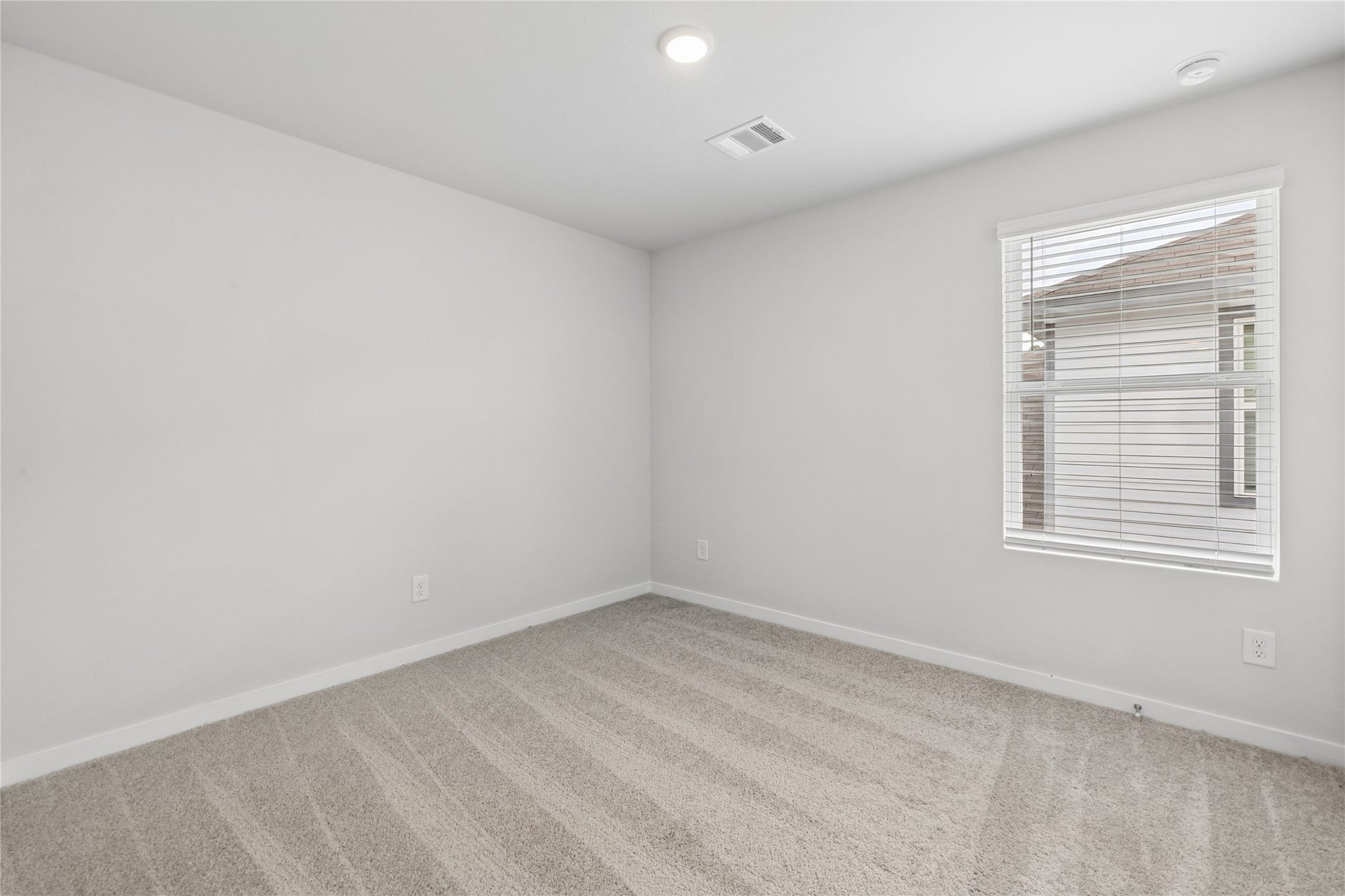 7806 Bergamot Cir, Magnolia, TX 77354 Bright and inviting bedroom with soft carpet flooring, neutral walls, and ample natural light from the window.