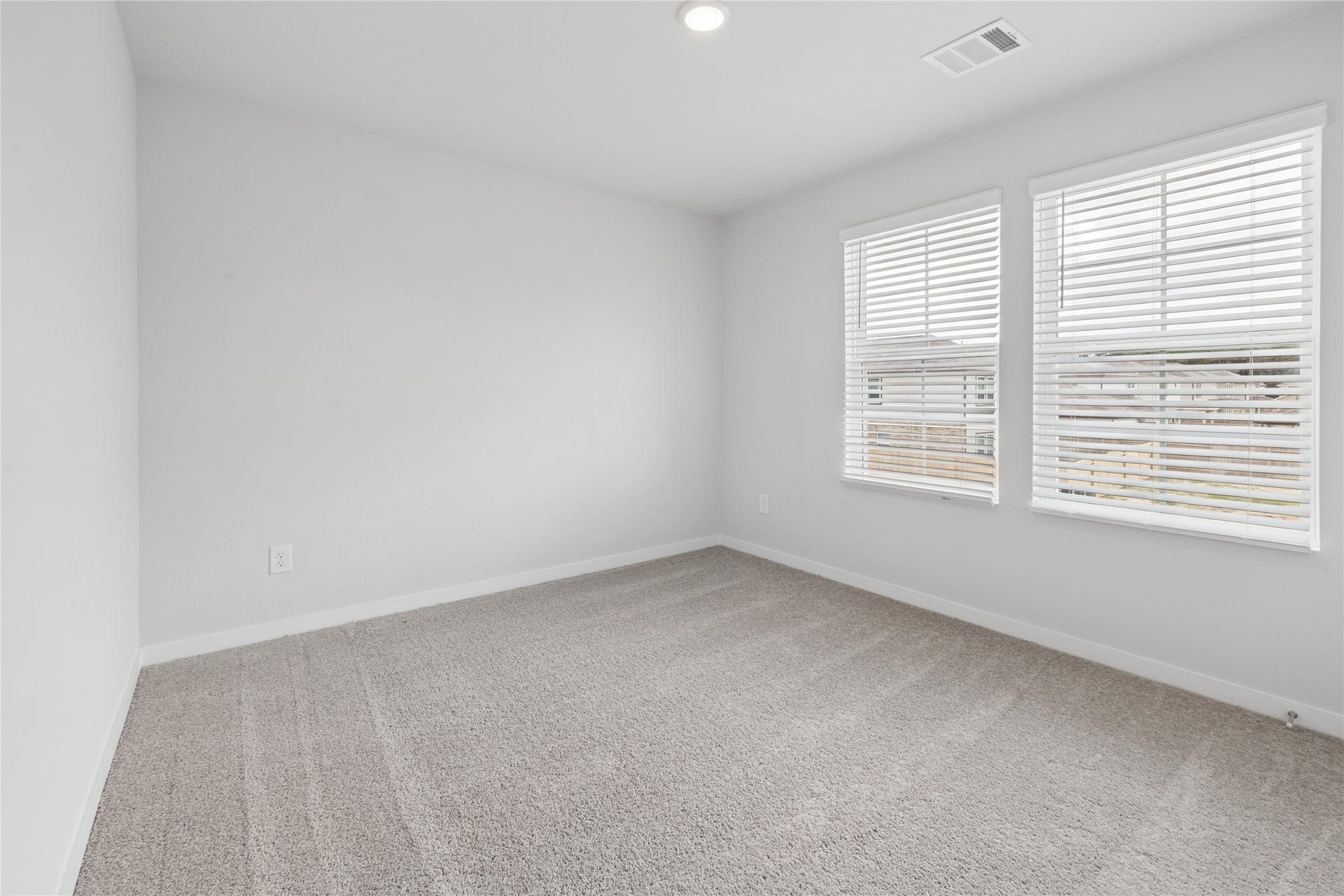 7806 Bergamot Cir, Magnolia, TX 77354 Bright and airy room featuring plush carpet and large windows, perfect for a cozy bedroom or home office.