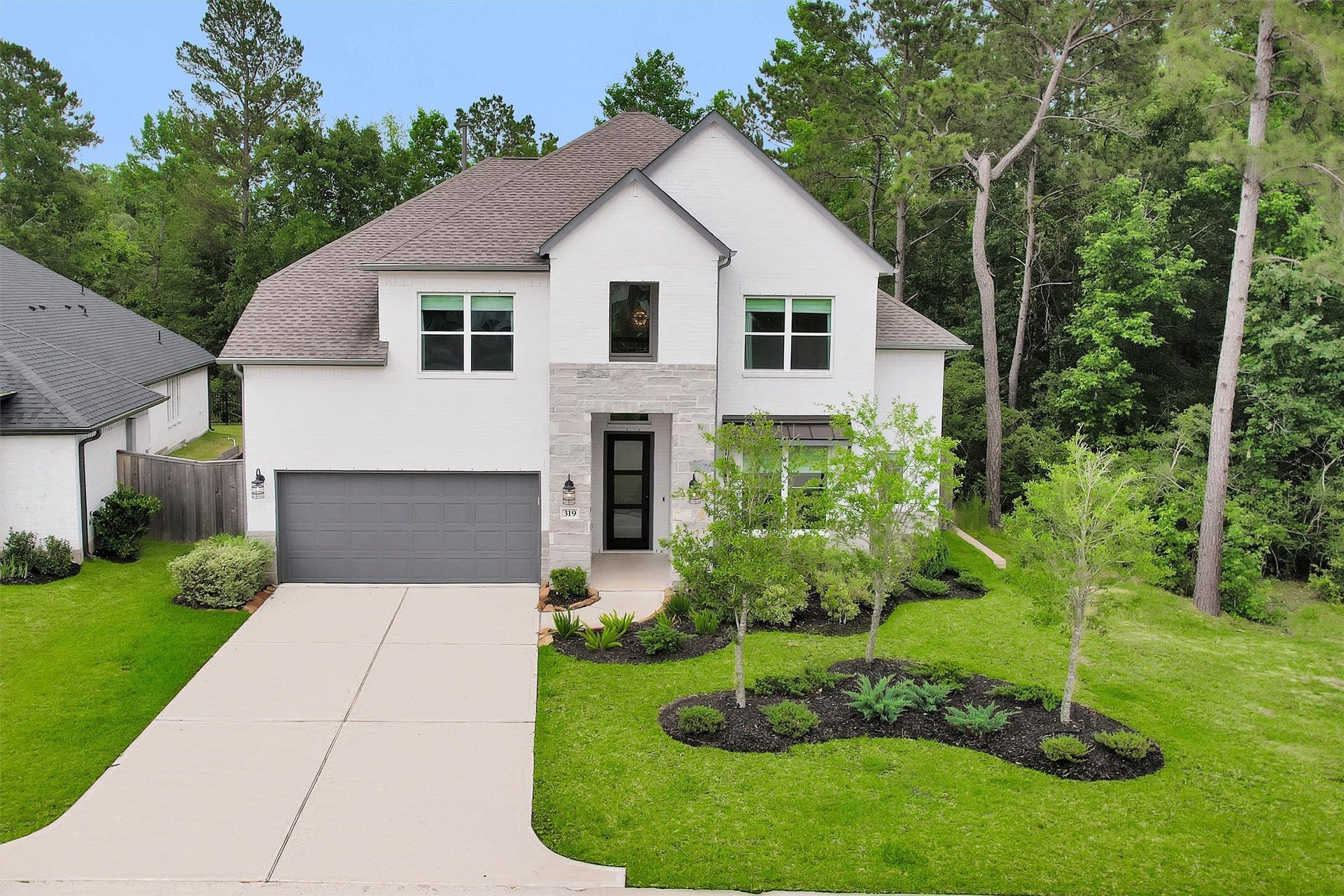 Stunning exterior elevation with incredible curb appeal, perfectly positioned on a premium lot with no back or side neighbors in Woodforest.