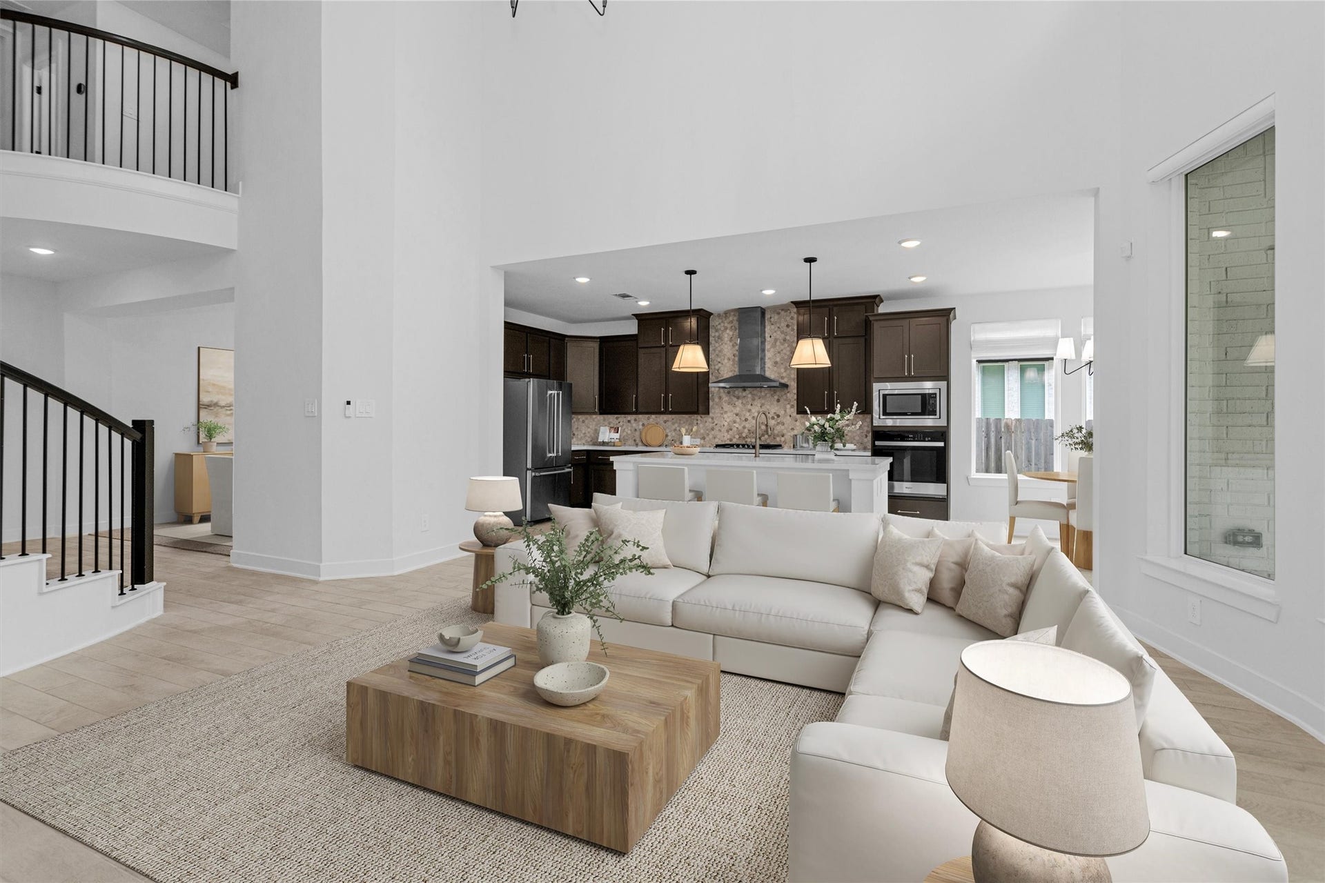 Open-concept living room seamlessly connects to the kitchen and breakfast area