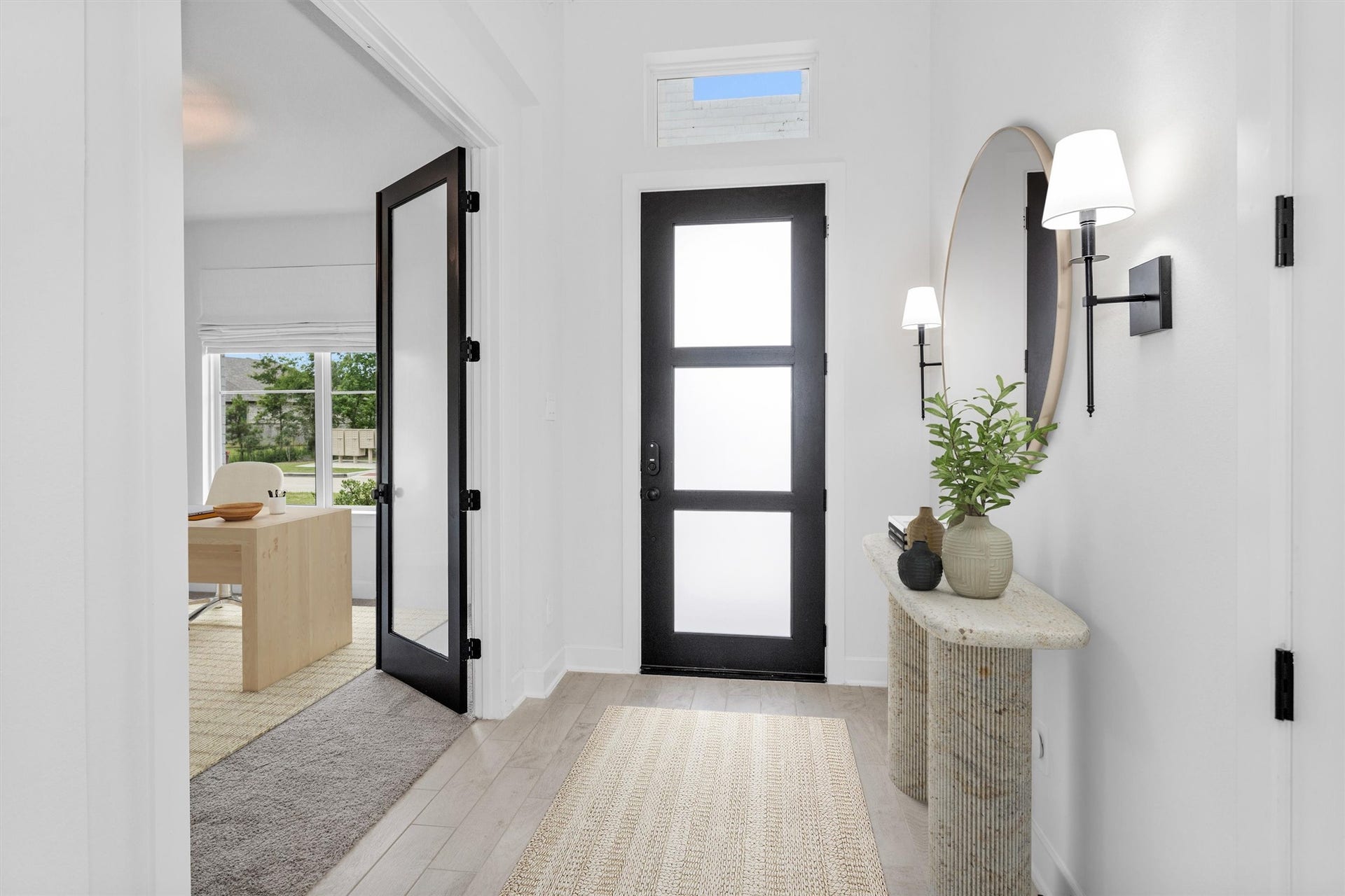 Elegant entry leading into the private study, highlighted by custom painted doors and an upgraded modern front door that adds style, sophistication, and a designer touch from the moment you arrive.