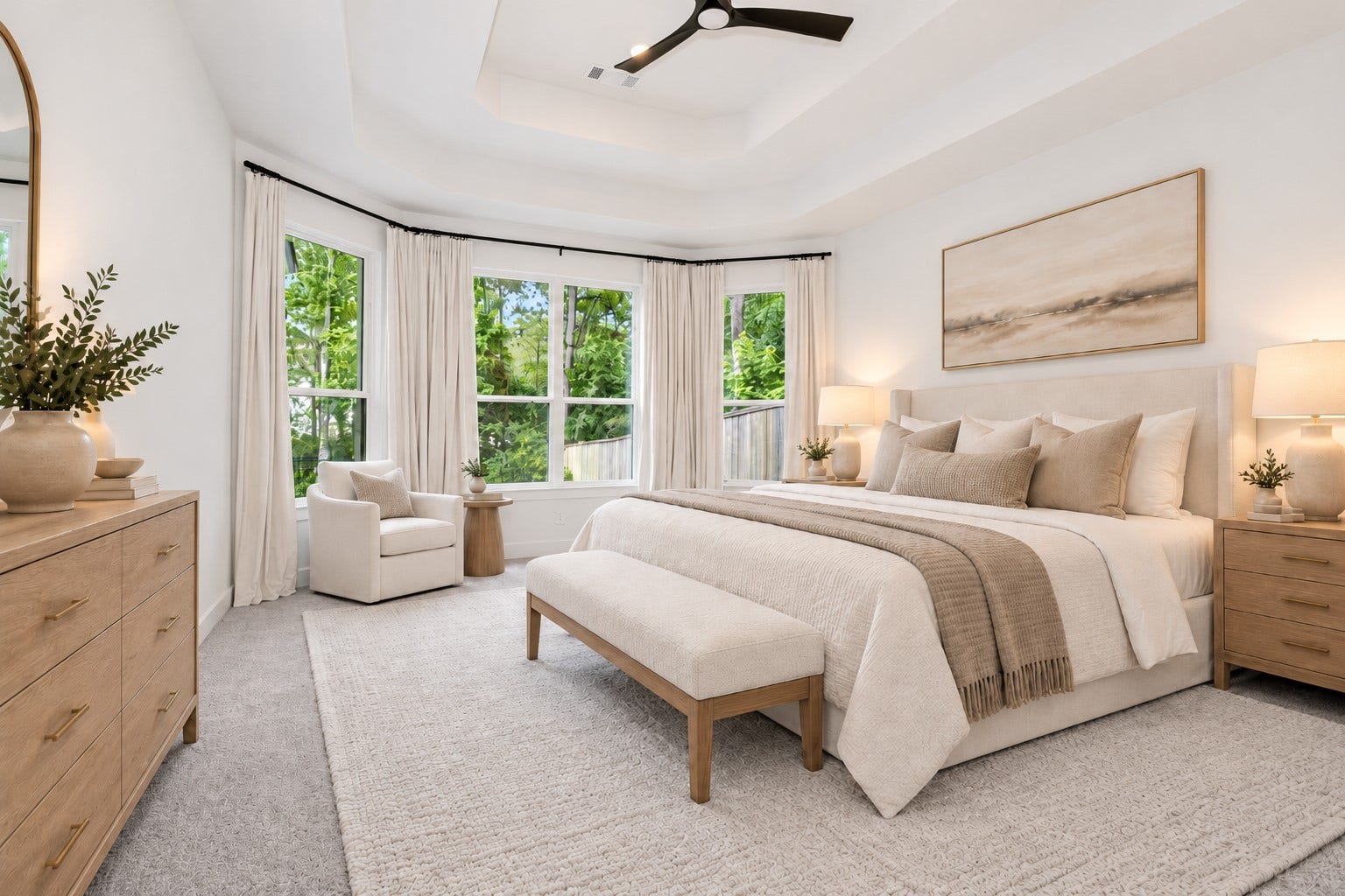 Private primary bedroom perfectly positioned with windows overlooking nature from both the side and back of the home, creating a peaceful retreat filled with serene wooded views and natural beauty.