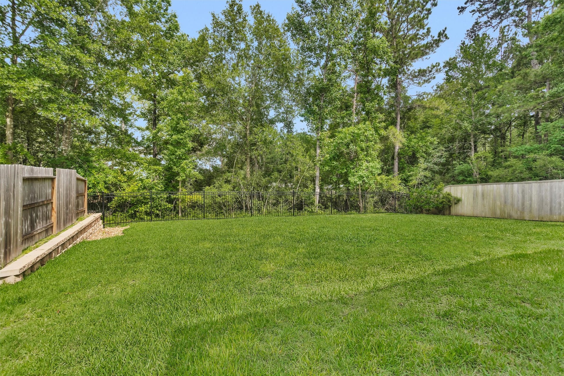 Peaceful backyard views enjoyed from the living room, breakfast area, kitchen, and primary bedroomcreating a seamless connection to nature and a serene backdrop throughout the home.