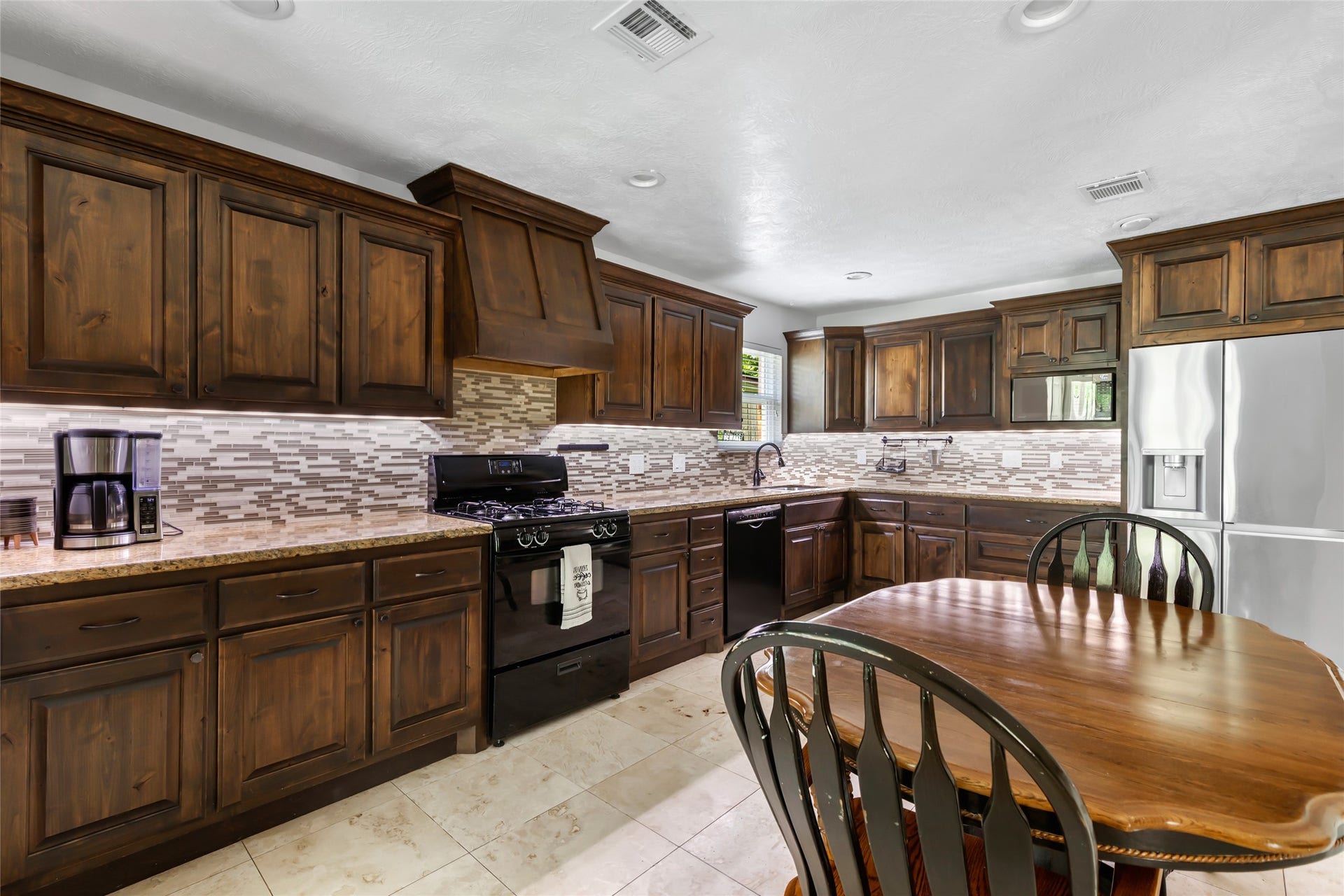 2543 Fountain View Street, New Caney, TX 77357 Spacious Kitchen with Granite Counters and Under Cabinet Lighting