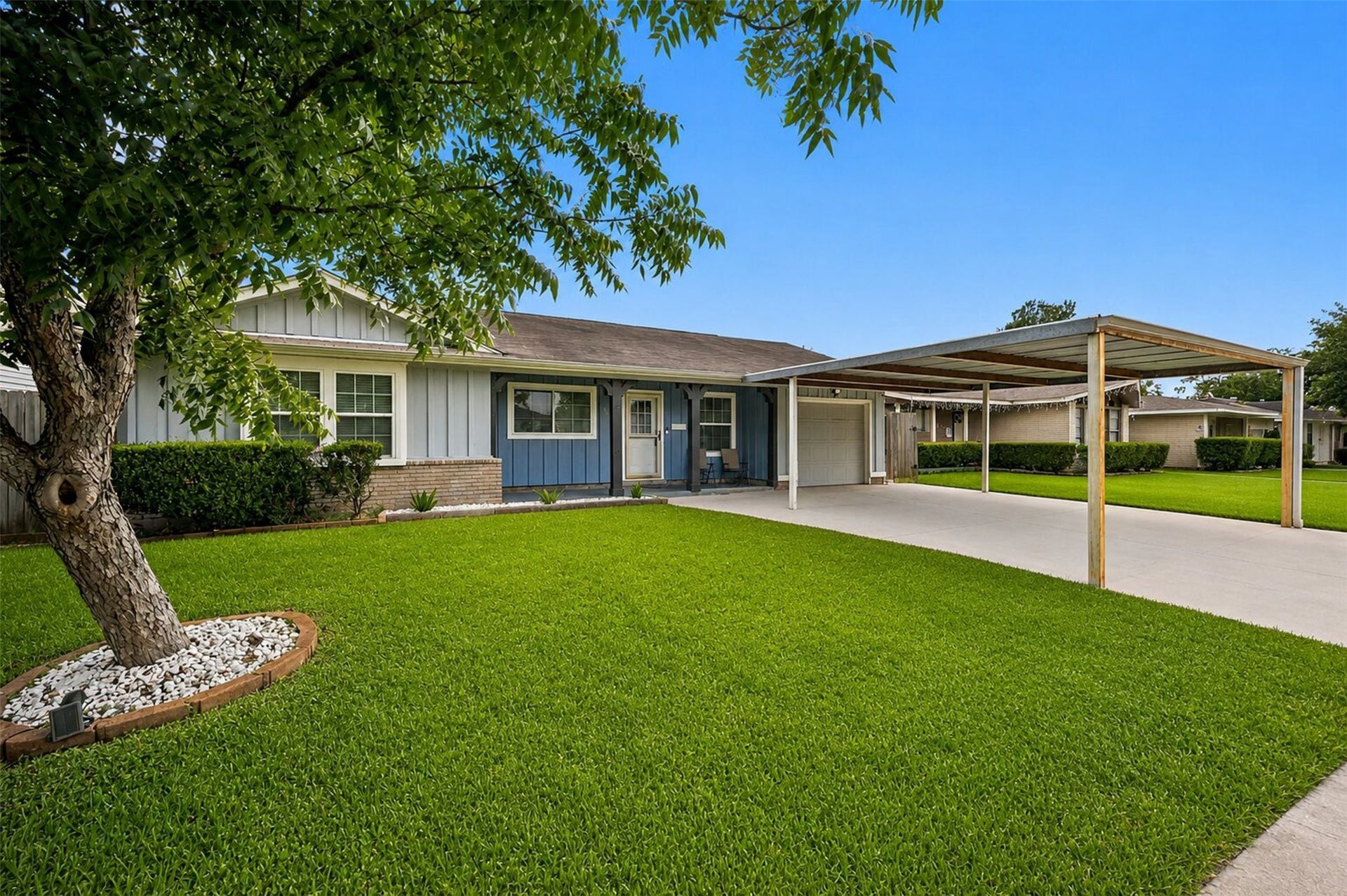 1306 Camden Road, Pasadena, TX 77502 Stunning front exterior featuring a beautifully manicured lawn, mature shade tree, attached garage, and a spacious covered carport, plenty of room for all your vehicles!