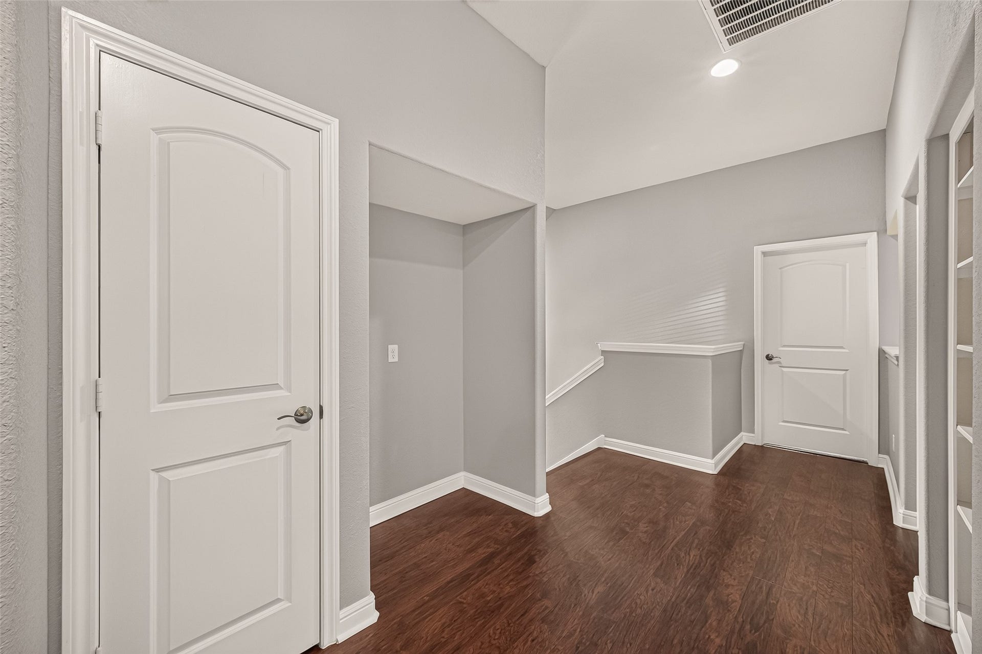 2826 Verdant Spring Trail, Katy, TX 77493 Bright and spacious hallway with elegant hardwood floors, neutral gray walls, and modern white doors, offering a welcoming and sophisticated entrance.