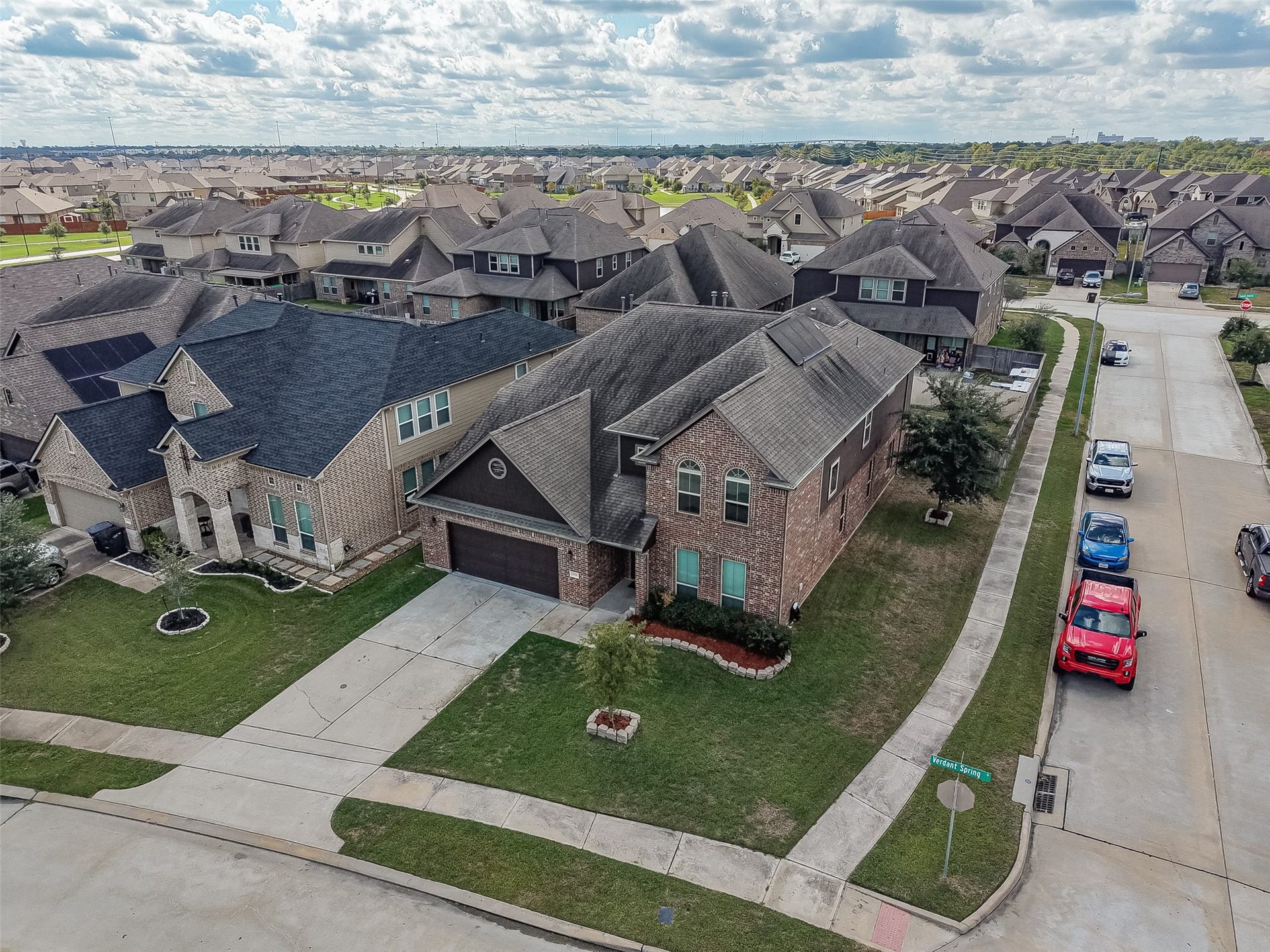 2826 Verdant Spring Trail, Katy, TX 77493 Charming two-story brick home on a spacious corner lot in a well-maintained neighborhood, featuring a two-car garage and lush green lawn.