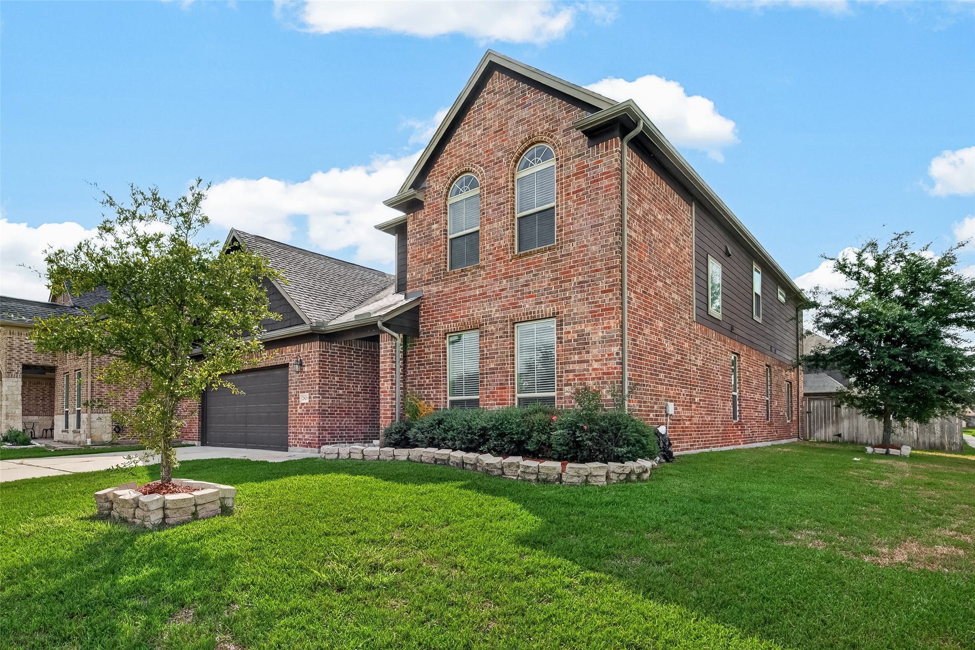 2826 Verdant Spring Trail, Katy, TX 77493 Stunning two-story brick home with charming curb appeal, featuring a landscaped front yard, a spacious driveway, and a two-car garage.