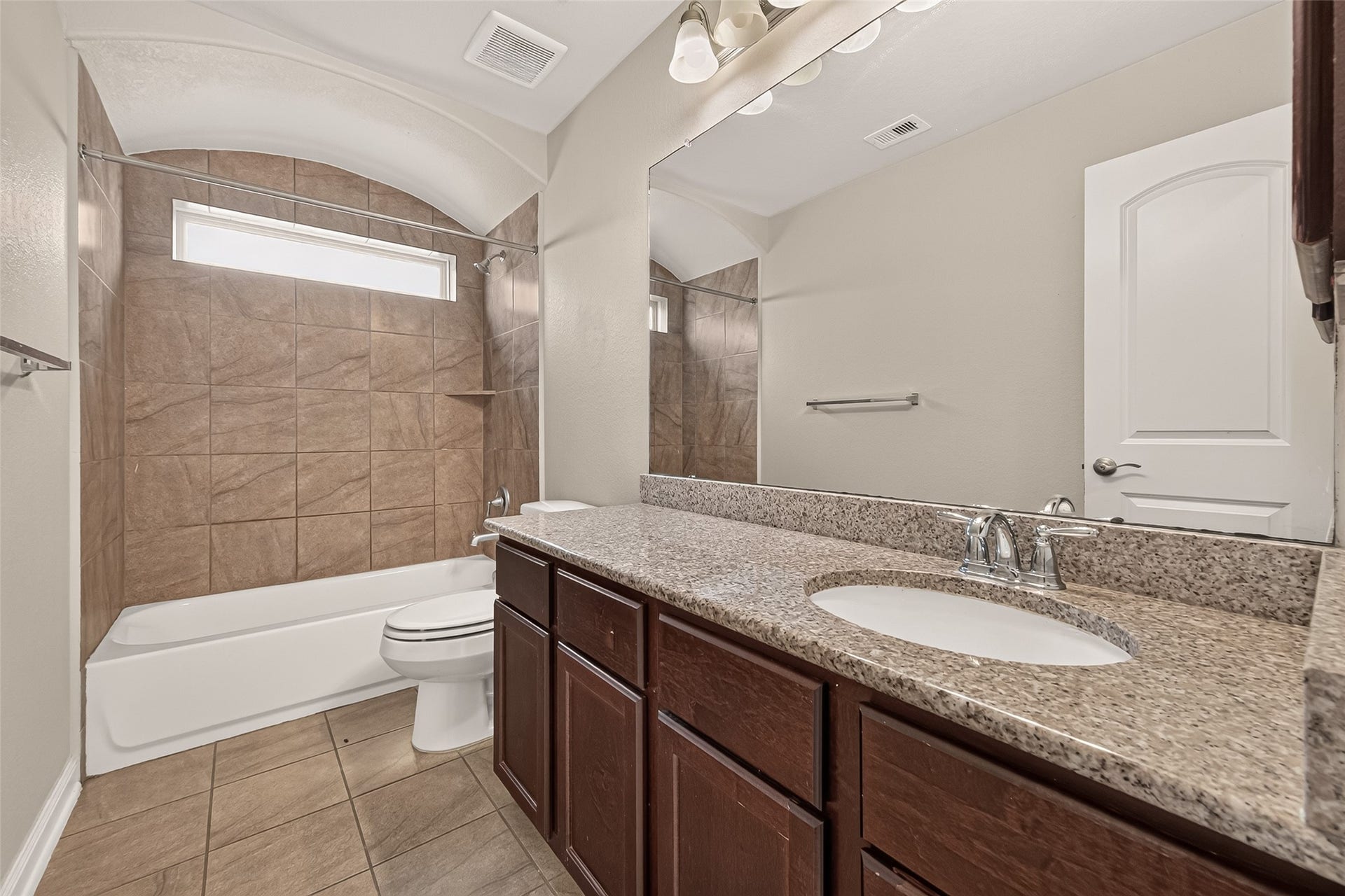 2826 Verdant Spring Trail, Katy, TX 77493 Spacious third bathroom featuring a granite vanity with a porcelain sink, rich dark-wood cabinetry, and an elegant tiled shower.