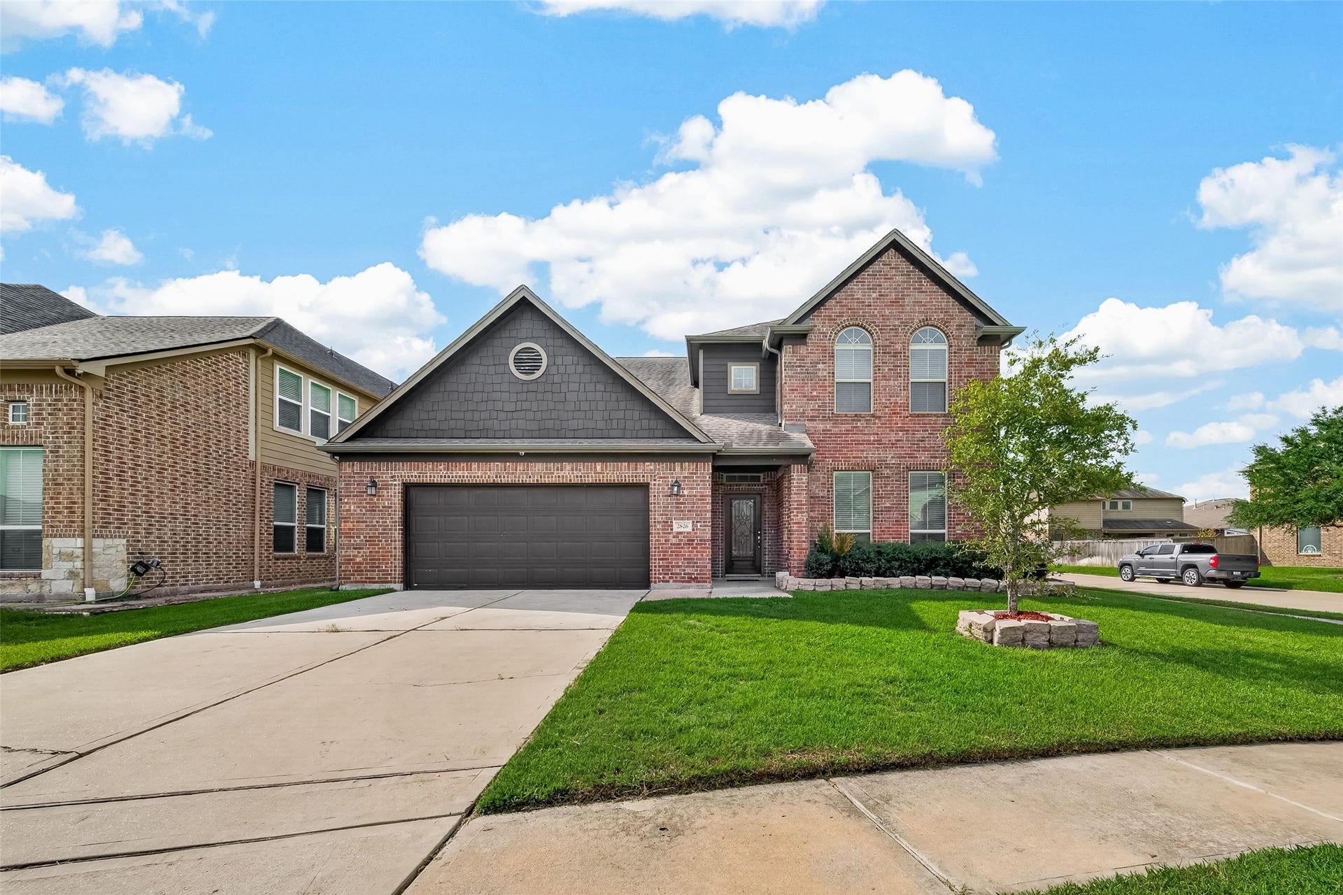 2826 Verdant Spring Trail, Katy, TX 77493 Charming two-story brick home featuring a spacious two-car garage, a well-maintained front yard, and excellent curb appeal