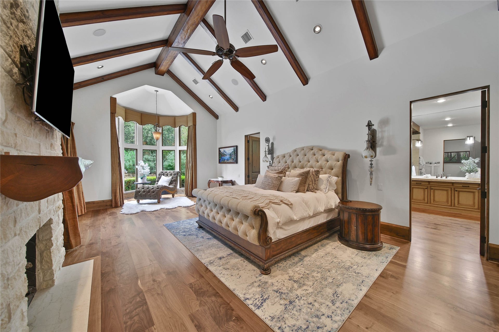 247 S Fazio Way, Spring, TX 77389 The primary bedroom suite is spacious, with vaulted beamed ceilings, a fireplace, and beautiful natural light.